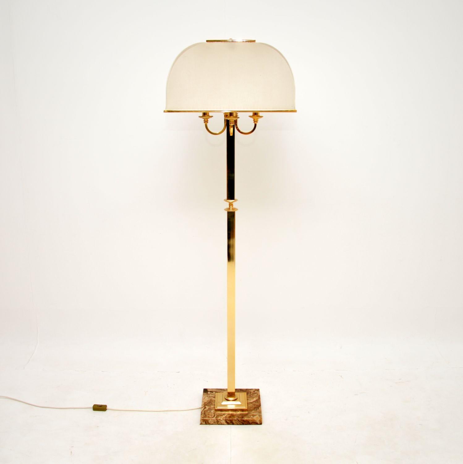 A stunning vintage brass and marble floor lamp, most likely made in Italy and dating from the 1970’s.

It is beautifully made, the brass frame sits on a gorgeous marble base. There are four outswept bulb holders that sit below a very impressive