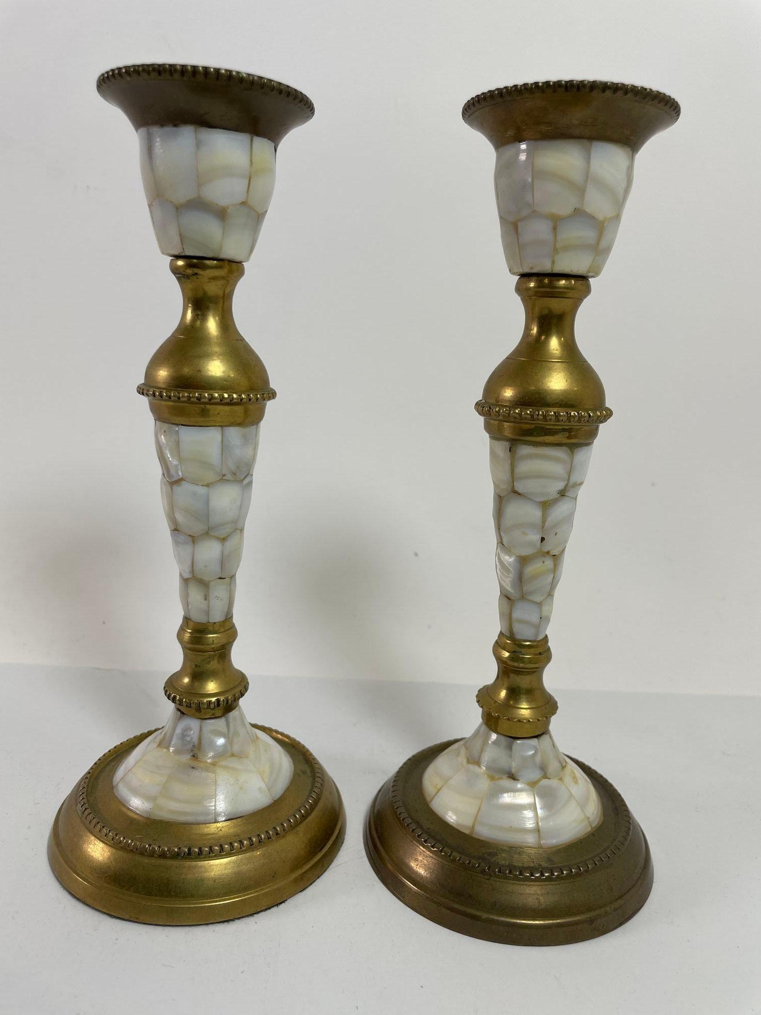 Vintage Brass and Mother Of Pearl Candlesticks.
A pair of vintage brass and mother of pearl candle holder.
These 8.25″ tall candlesticks are adorned with three sections of beautifully inlaid mother of pearl.
There is a beaded design on the brass
