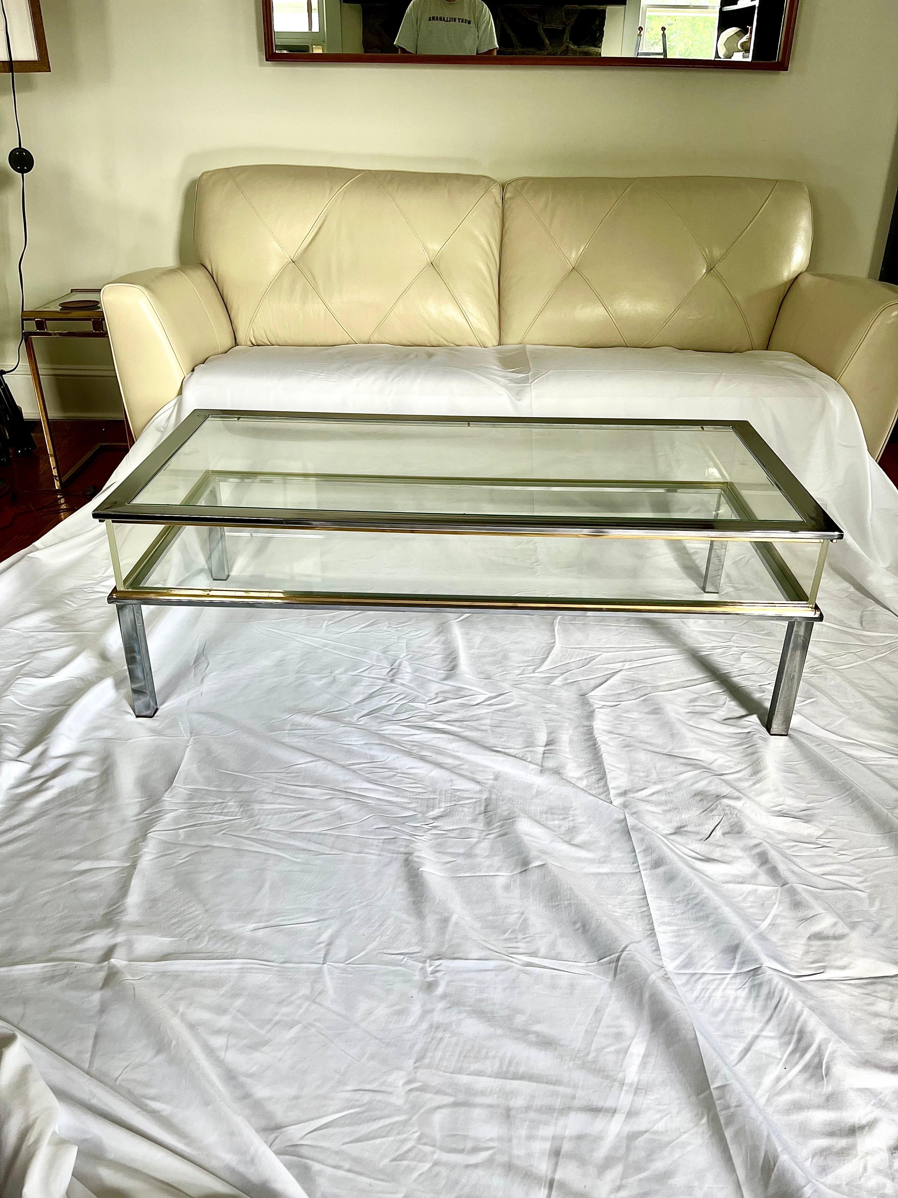 Unique Vitrine coffee table with top sliding open to provide vitrine display case. Rectangular shape with clean lines. Beautiful contrast with brass/bronze and nickel/chrome. Plexiglass display walls. 
Curbside to NYC/Philly $450
