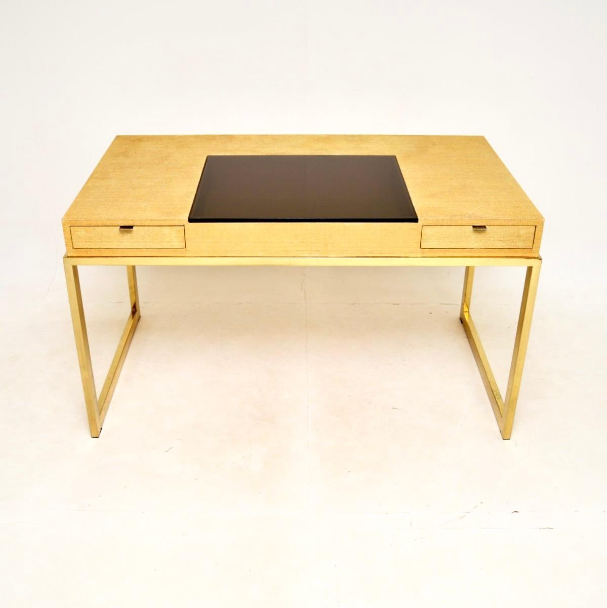 A very stylish and unusual vintage brass and rattan desk. This was made in England, it dates from around the 1970’s.

It is very well made and has a lovely design, with the rattan clad top attached to a brass base. There are two drawers and in the