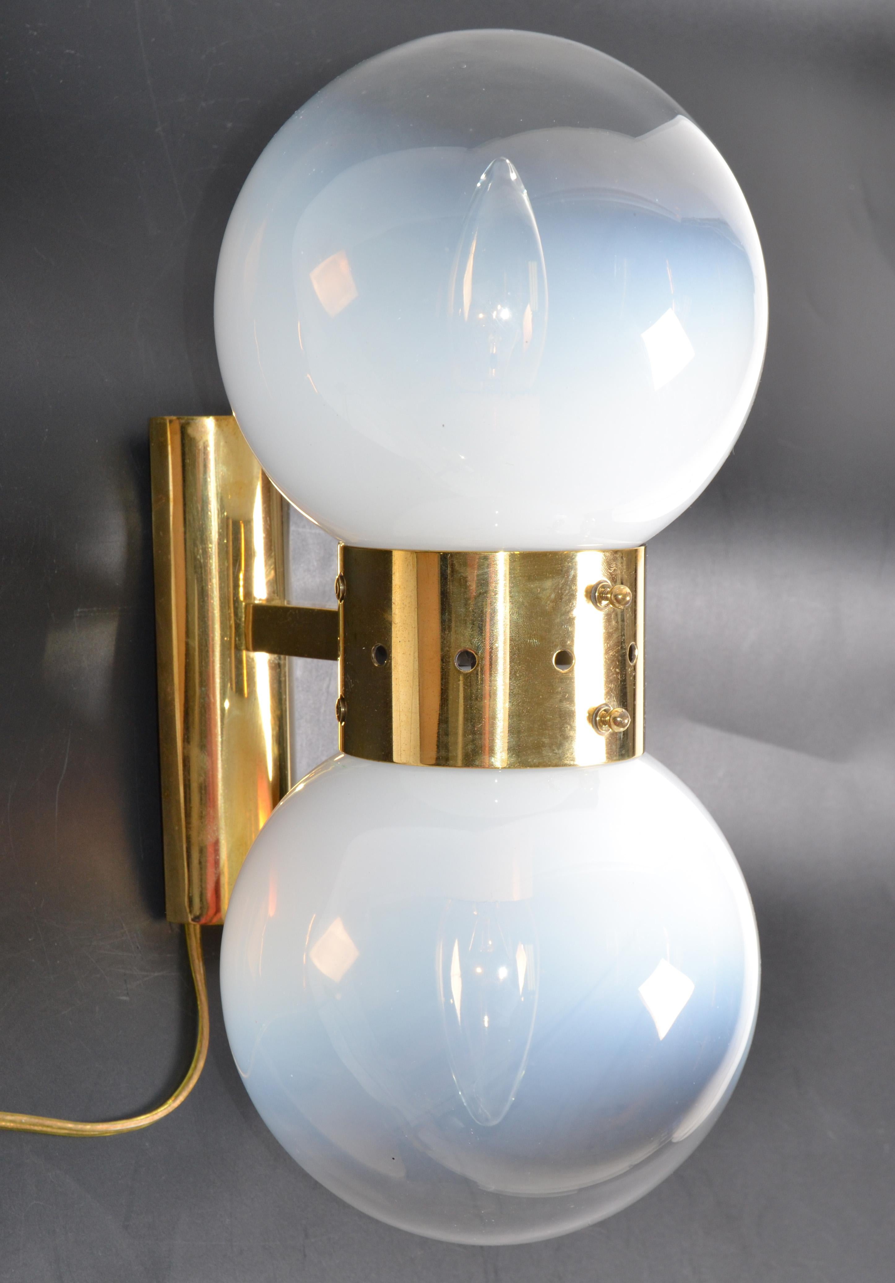 Italian Art Deco brass & blown murano glass sconces, wall lights.
Two round glass shades mounted on a polished brass frame.
In perfect working condition and each sconce takes 2 E14 light bulbs.
Brass back plate measures: 6.75 x 2 x 1