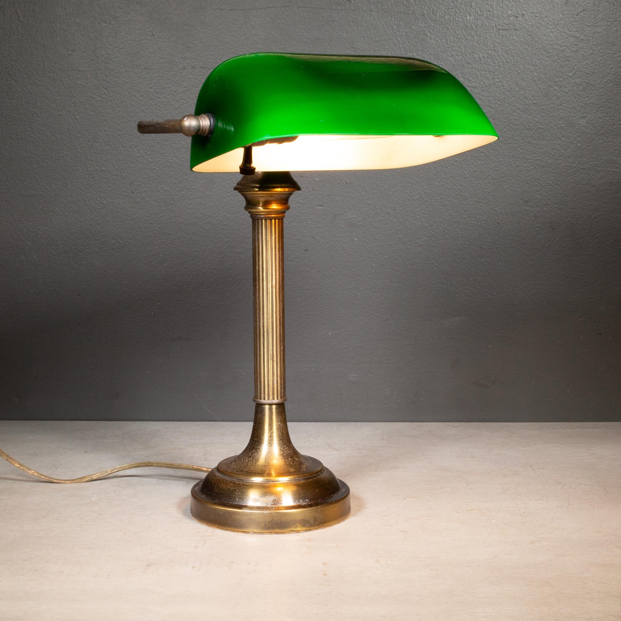 ABOUT

An original brass Banker's desk lamp with green glass shade. 

    CREATOR Unknown. 
    DATE OF MANUFACTURE c.1950-1970. 
    MATERIALS AND TECHNIQUES Brass, Glass. 
    CONDITION Good. Wear consistent with age and use. Functions properly.