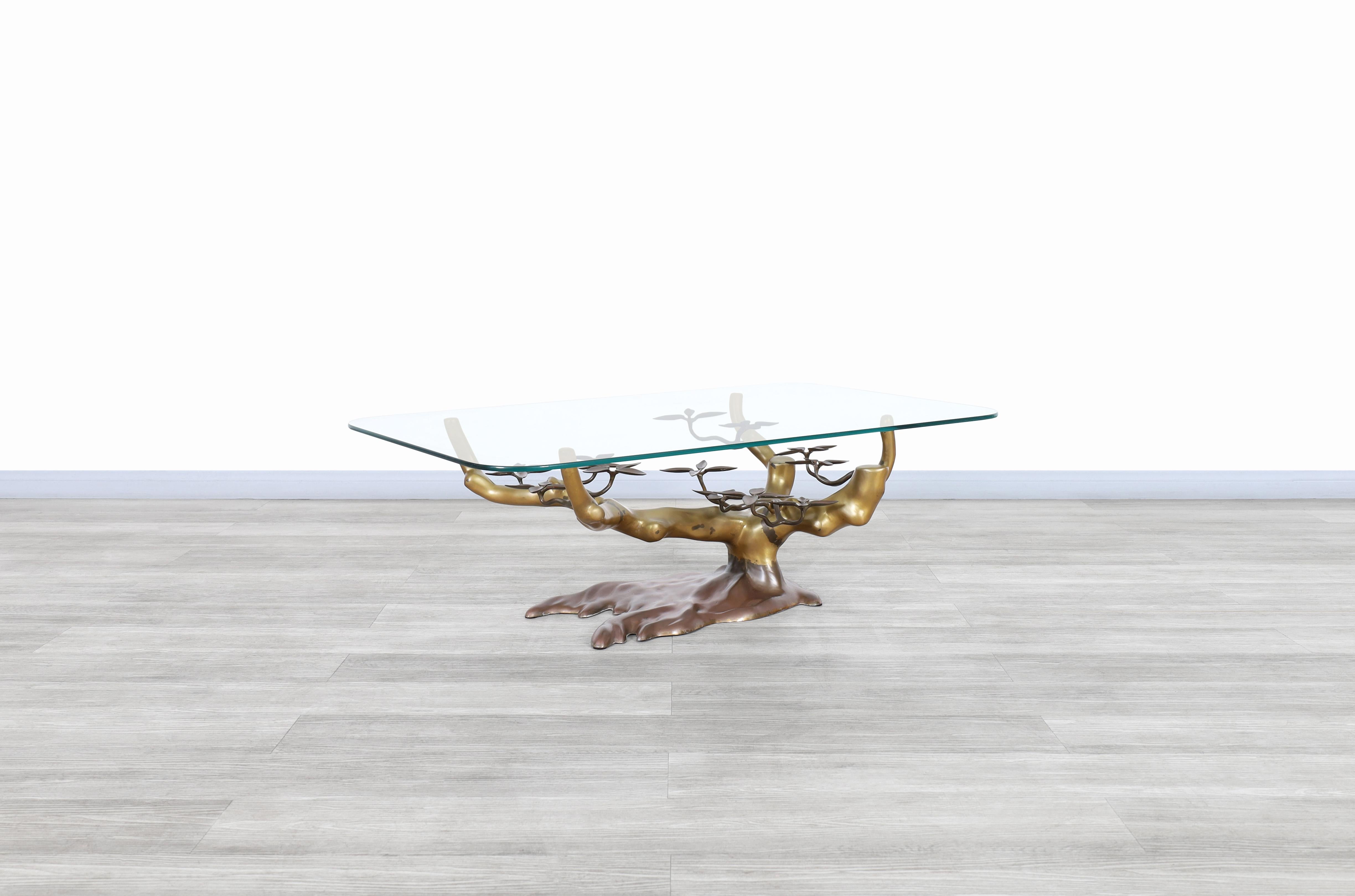 Beautiful vintage brass “Bonsai” coffee table designed by Willy Daro and manufactured in Belgium, circa 1970s. This table has a solid brass base shaped in the form of a bonsai tree, in which we can appreciate the quality put into this design and the