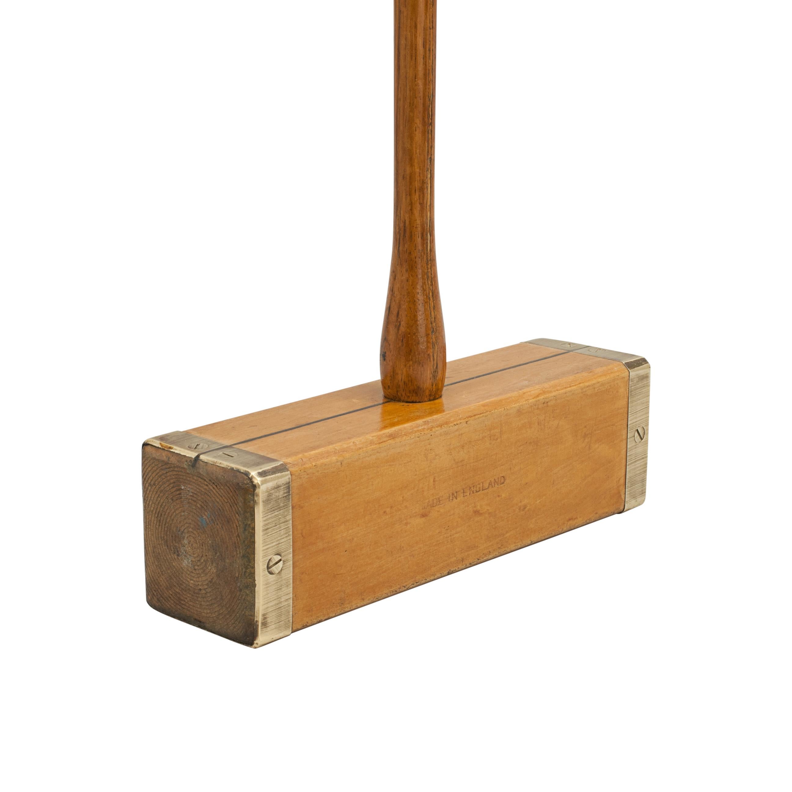 Vintage brass bound Jaques croquet mallet.

A good square head, brass bound boxwood croquet mallet by Jaques. The square head with line guide, attached to a sprung hickory handle with thumb grip at the top and a restrung cord handle. A good usable
