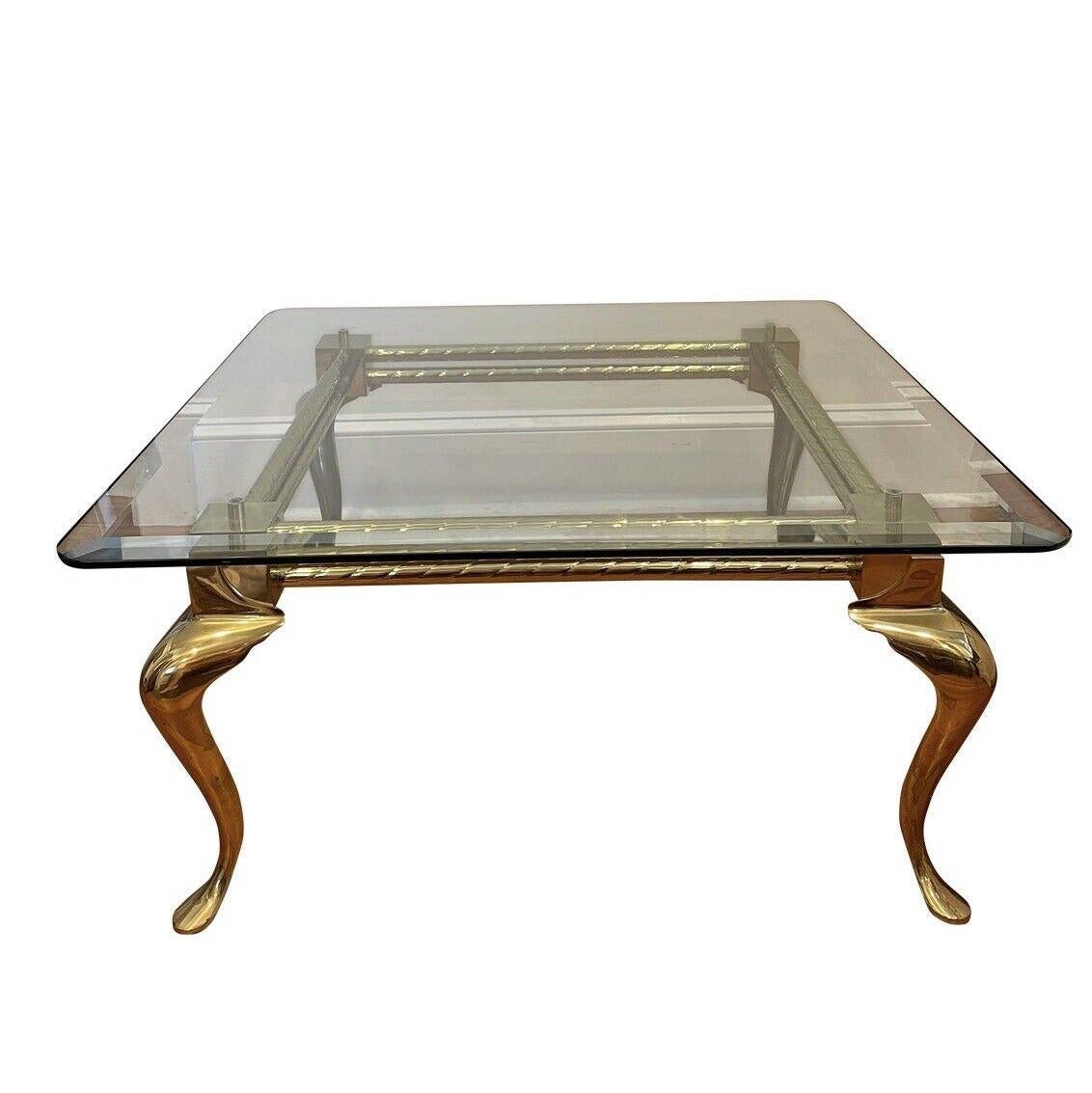 Elegant modern brass coffee table with cabriole legs and Industrial design frame with twist stretchers. Beveled 1/2