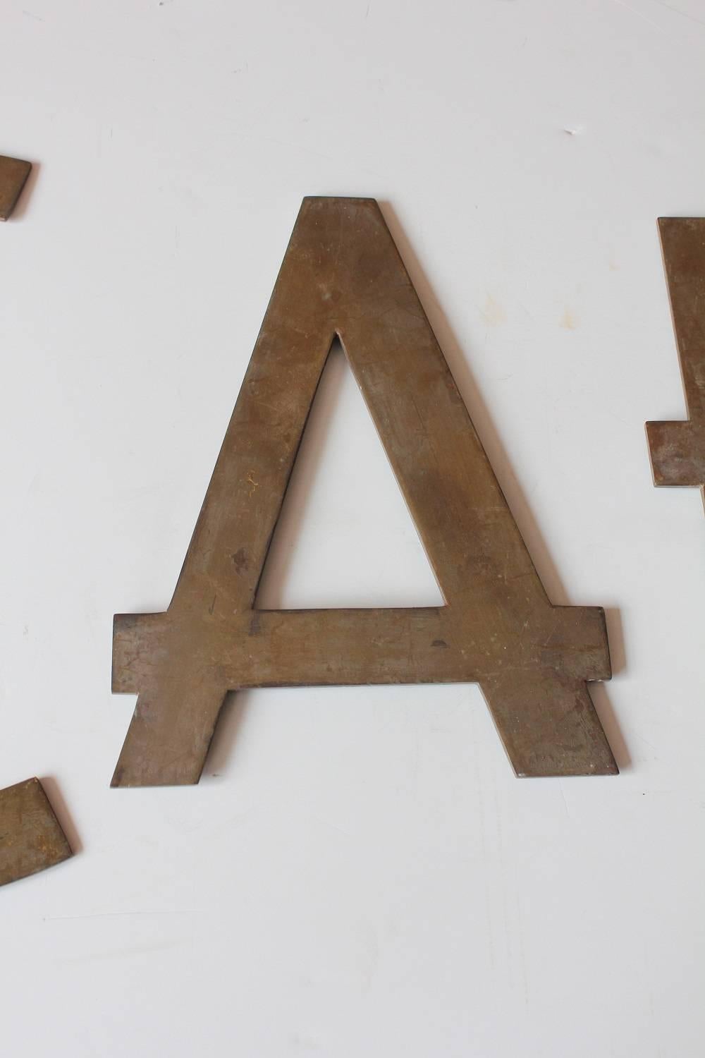 Vintage brass CAFE sign. Four individual letters. Original patina. Each letter has hanging hooks on the back. Measures: C: 18.5