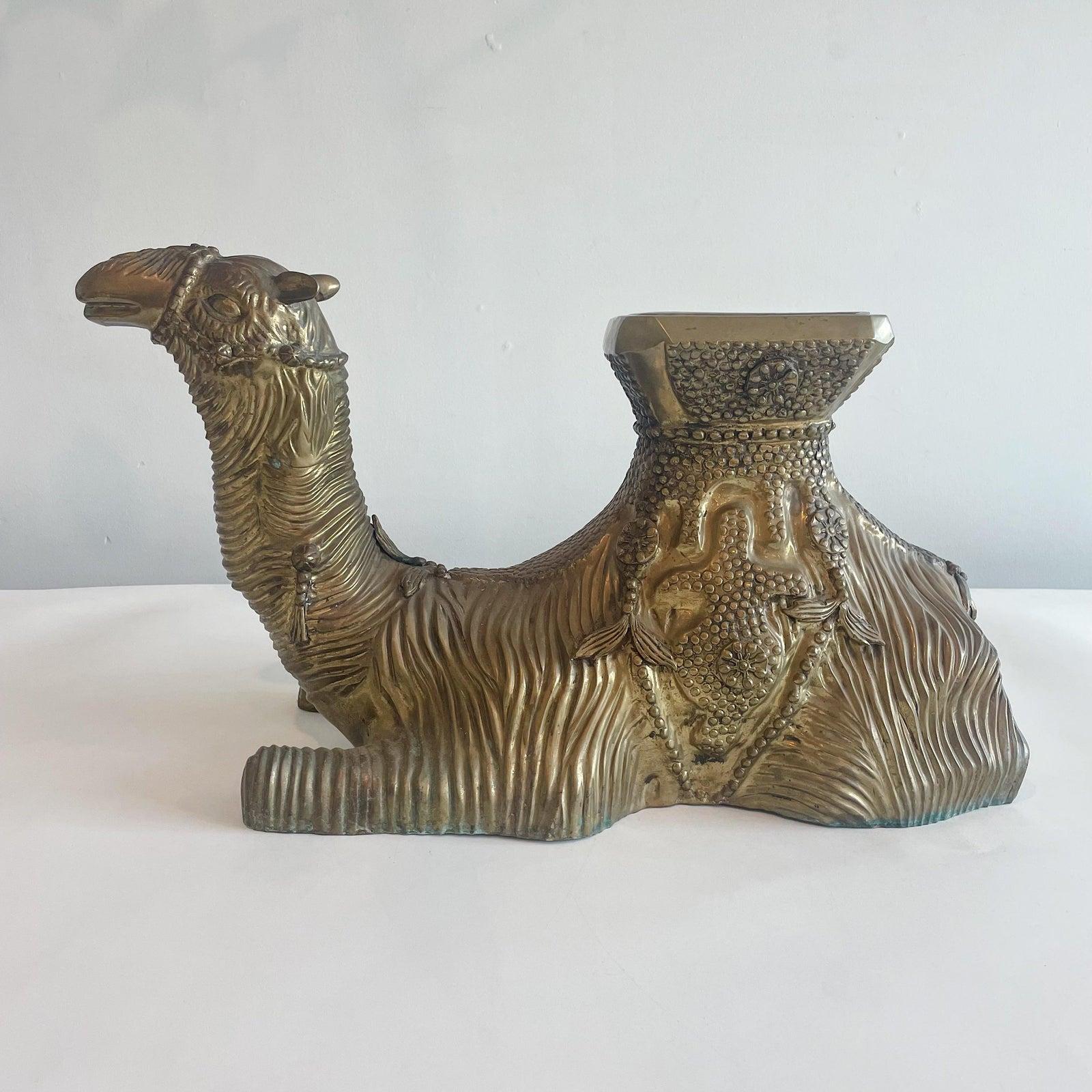Unusual brass camel seat or small table. This can accommodate a small piece of glass to make it an occasional table. Unsigned.
