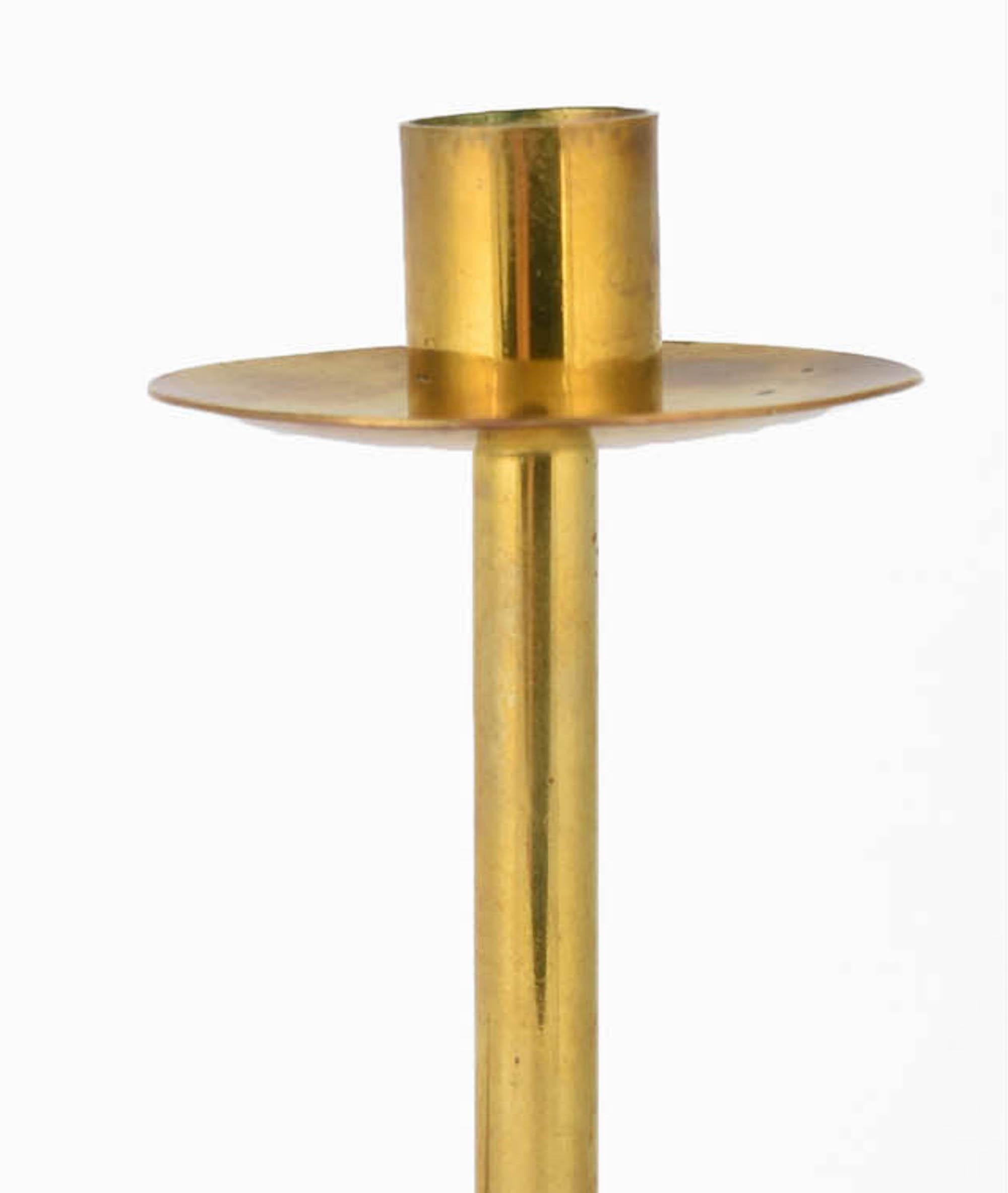 Brass Candlestick and Ashtray is an original decorative pair of objects realized in the second third of the XX Century. 

Original brass. Made in Germany. 

Created by Hayno Focken.

This pair of objects includes: one brass candlestick (h. 23