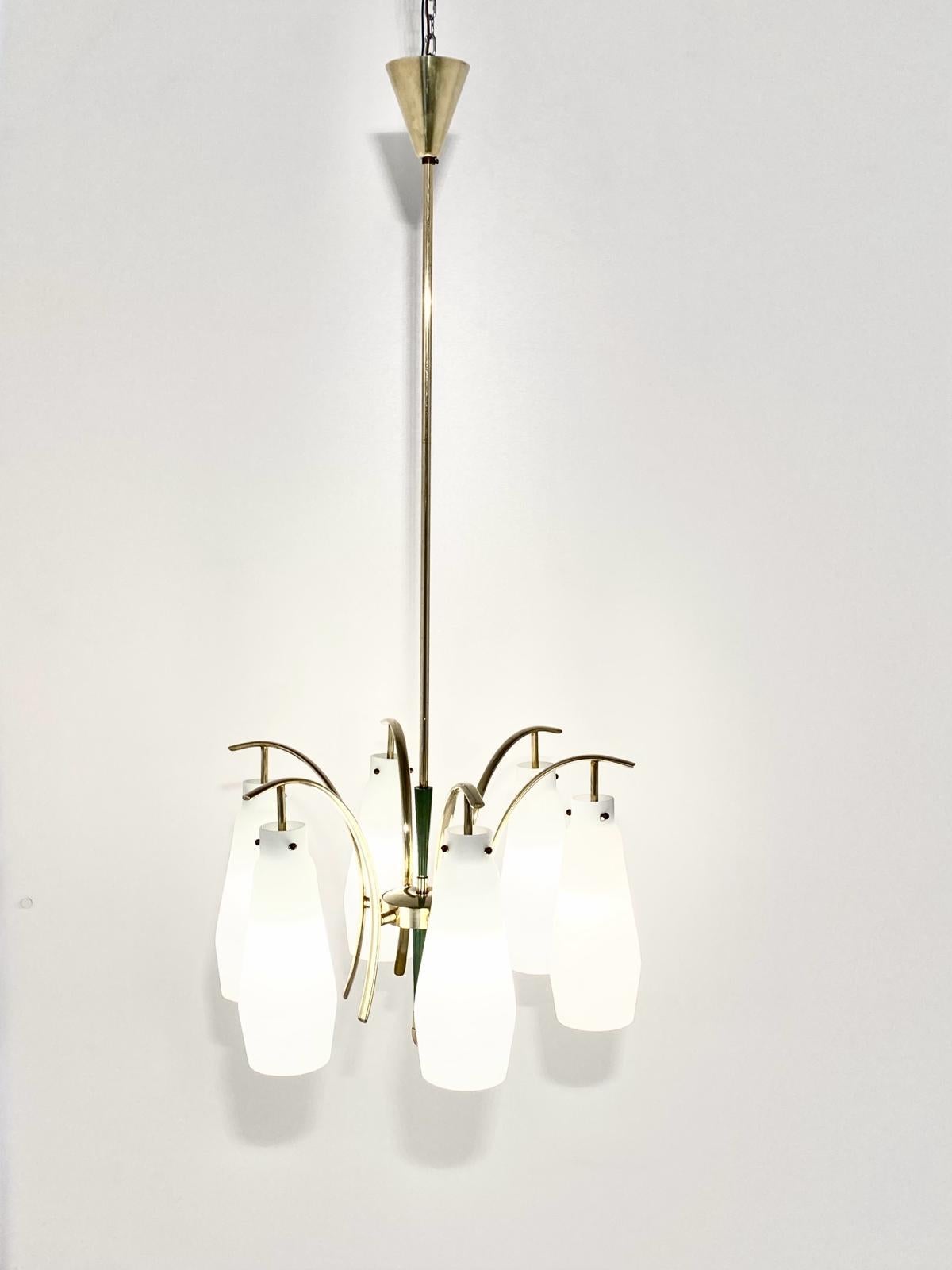 A unique vintage Stilnovo chandelier in pure mid century style.
The chandelier, manufactured in Italy in the mid-1950s by iconic Stilnovo company, is made of six brass arms and six frosted glass lampshades. The lamp frame is also made of brass and