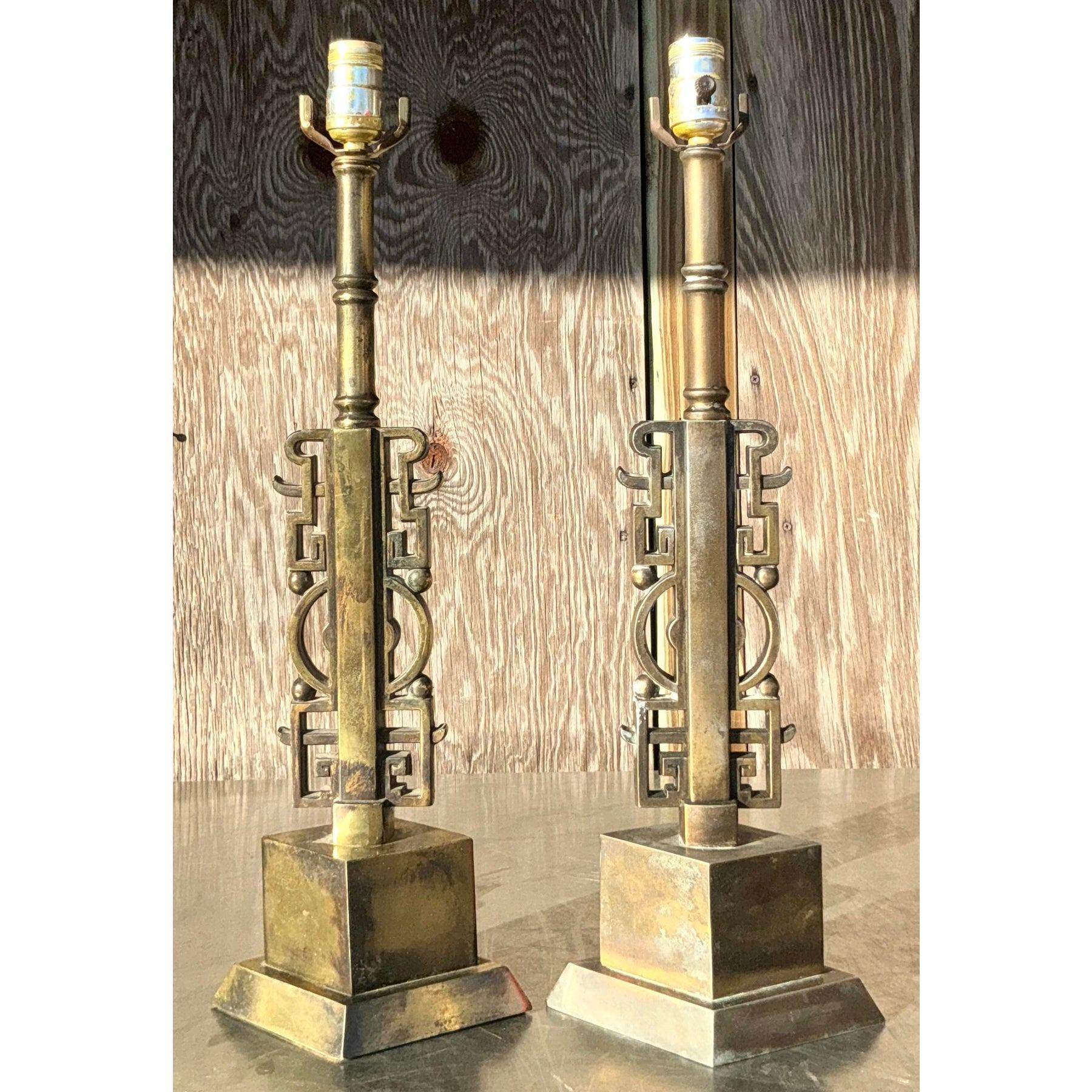 Add timeless sophistication to your decor with this pair of vintage brass character lamps inspired by the designs of James Mont. Featuring sculptural brass bases with intricate character motifs, these lamps exude elegance and artistry. Their warm