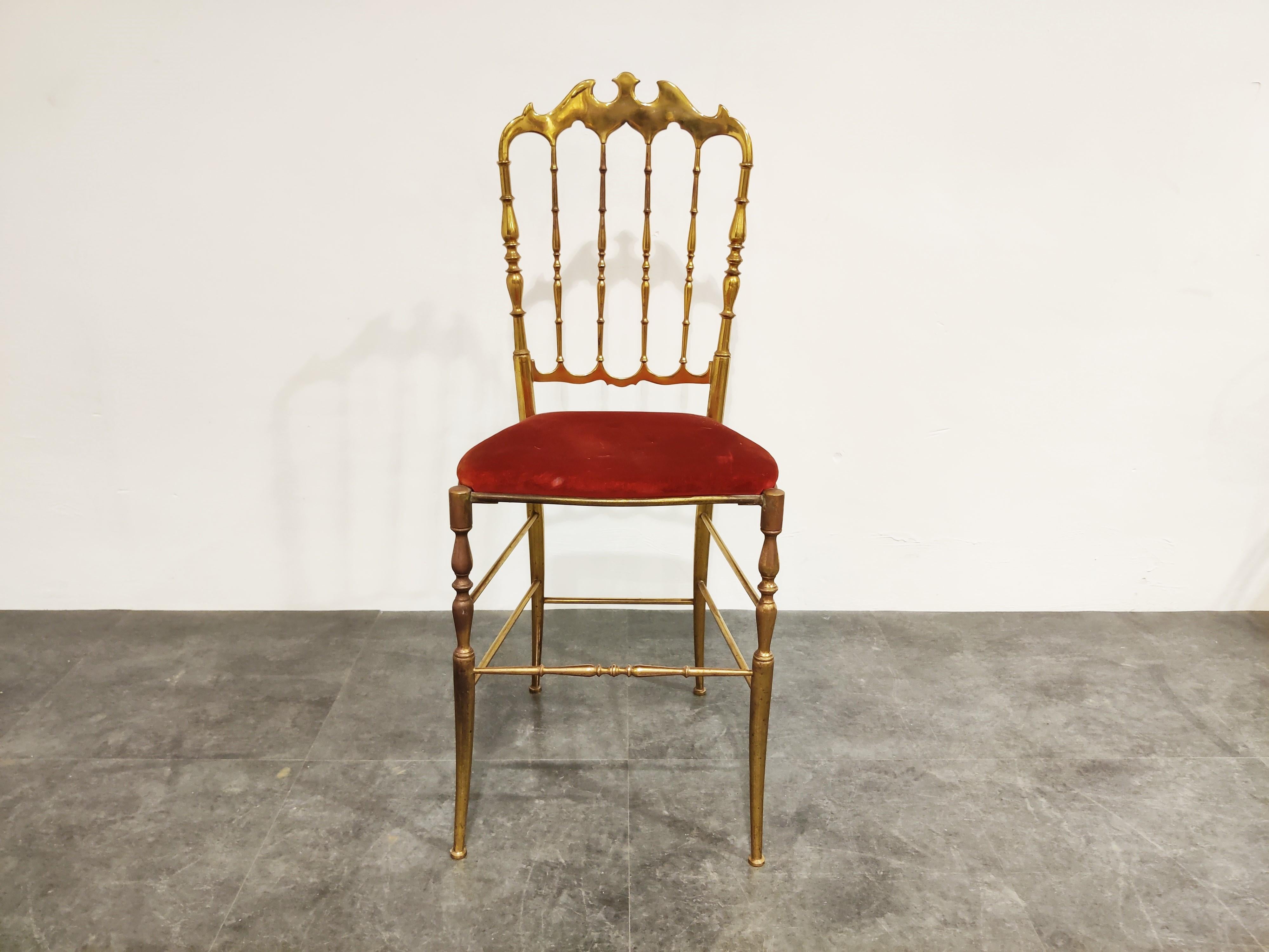 Beautiful and elegant Chiavari chair in polished brass and a red velvet seat.

Designed by Giuseppe Gaetano Descalzi and produced since the early 19th century in the Ligurian town of Chiavari, Italy.

This chair can be used for a desk, as
