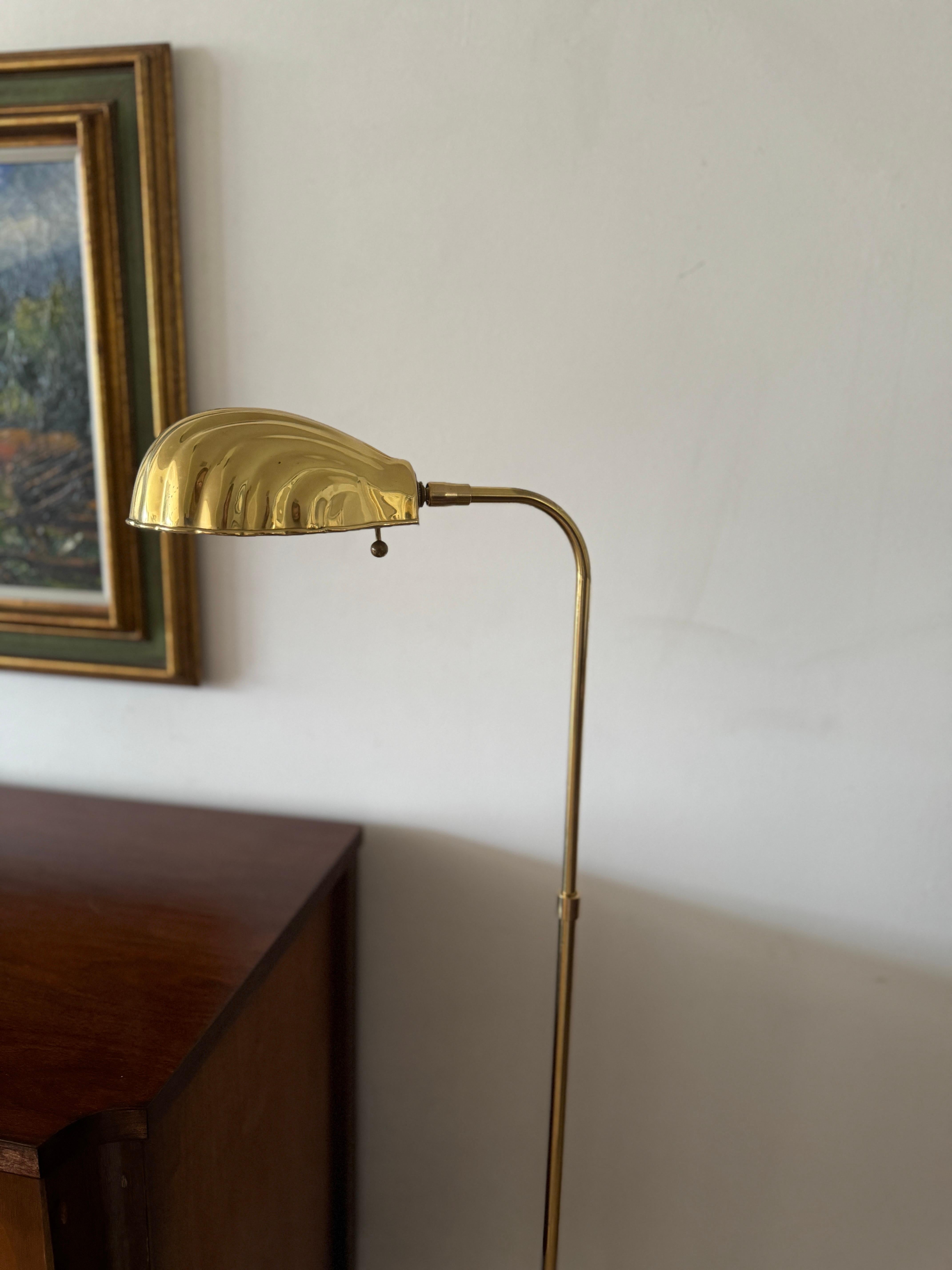 Vintage brass shell shade floor lamp with base diameter of 10 inches. Extends up to 48 inches in height.