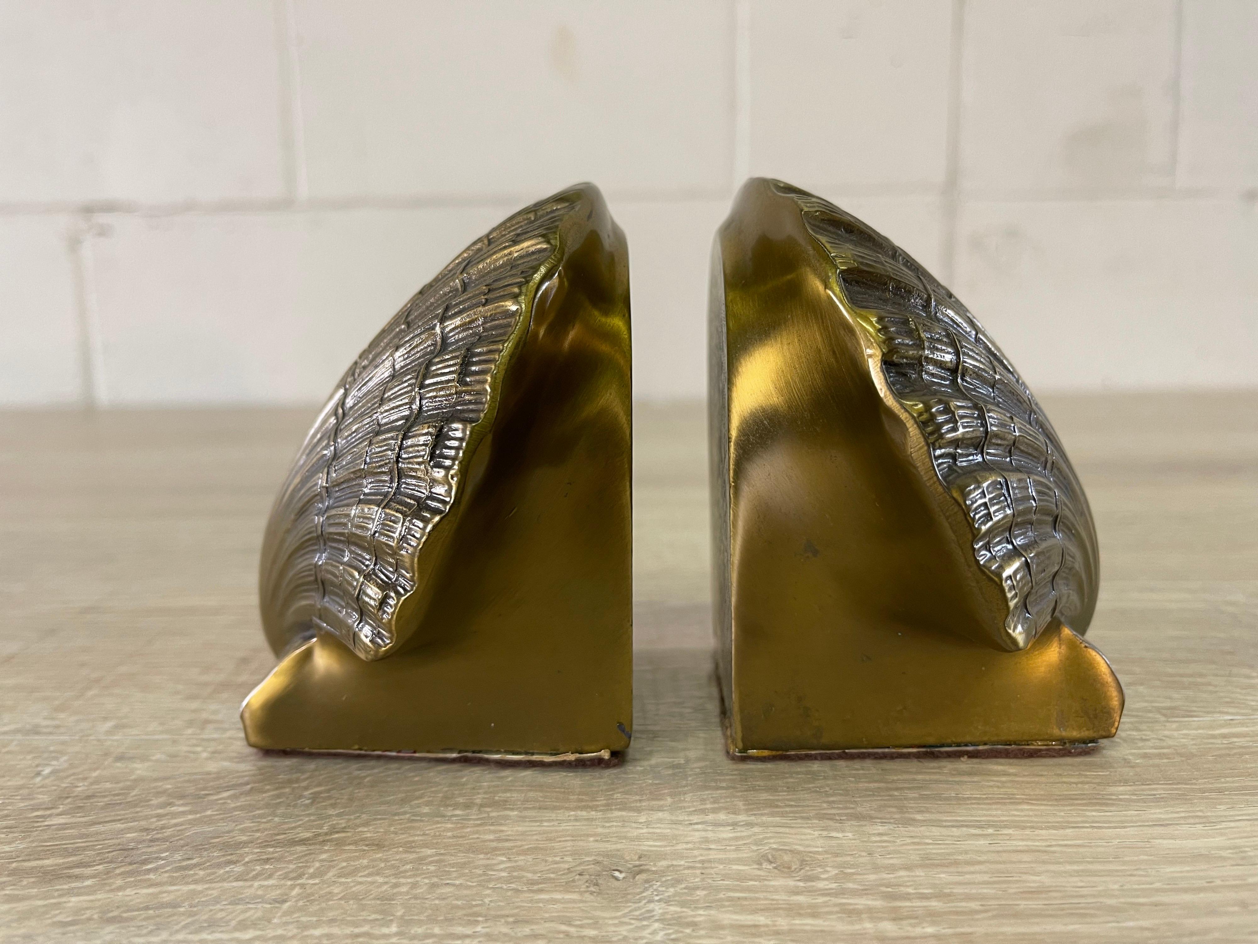 Vintage 1970s pair of brass clam shell bookends. The bookends are heavy and can hold thick books. Marked.