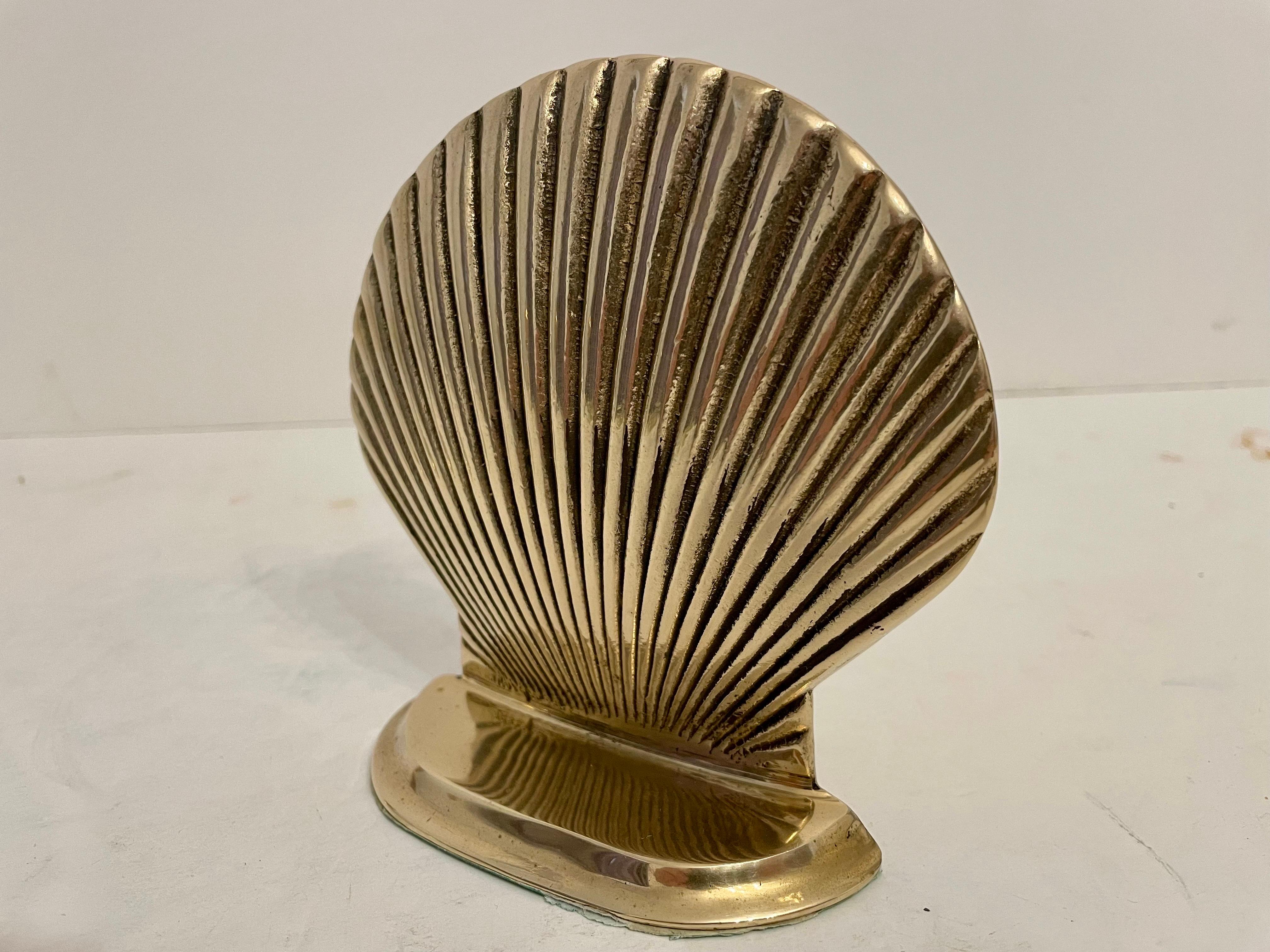 Vintage brass clam shell seashell bookends. Good condition. Has nice weight to hold a stack of books. Great for your beach house! Any dark areas are reflection only.