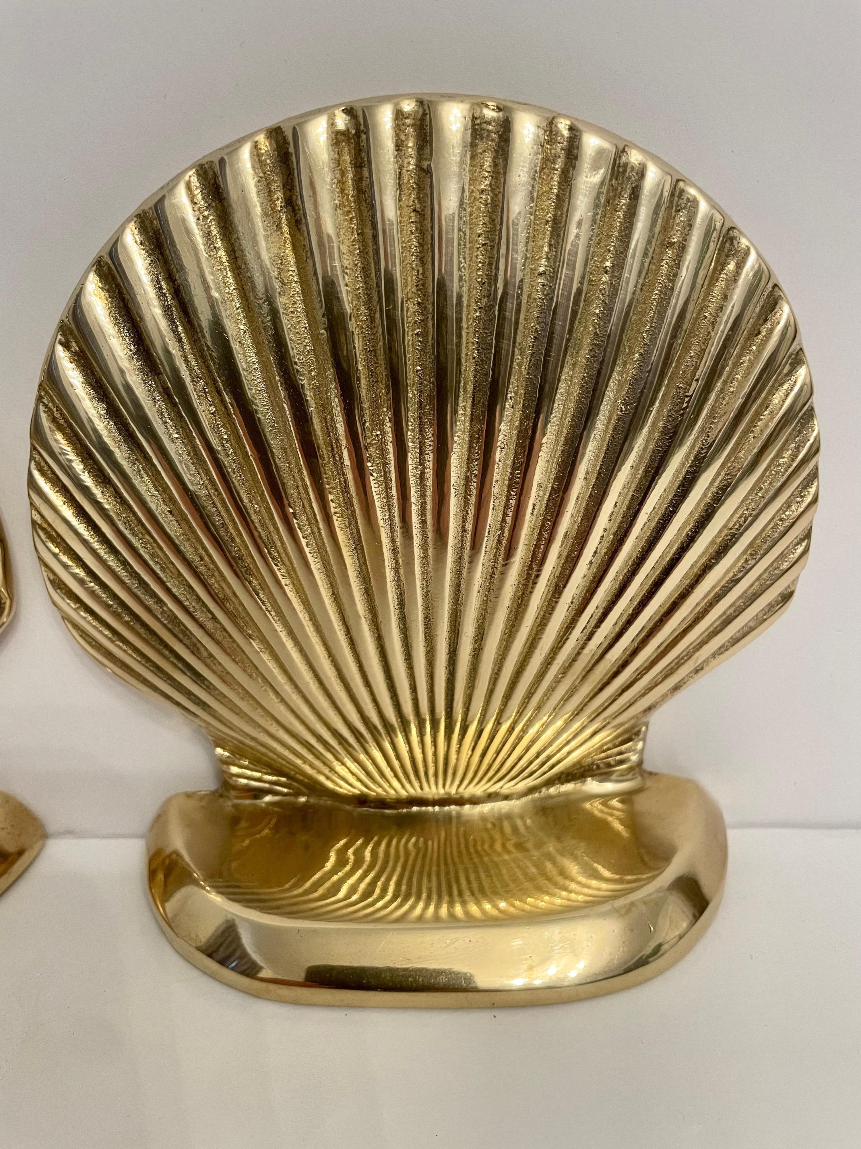 Vintage brass clam shell seashell bookends. Good condition. Has nice weight to hold a stack of books. Great for your beach house! Any dark areas are reflection only.