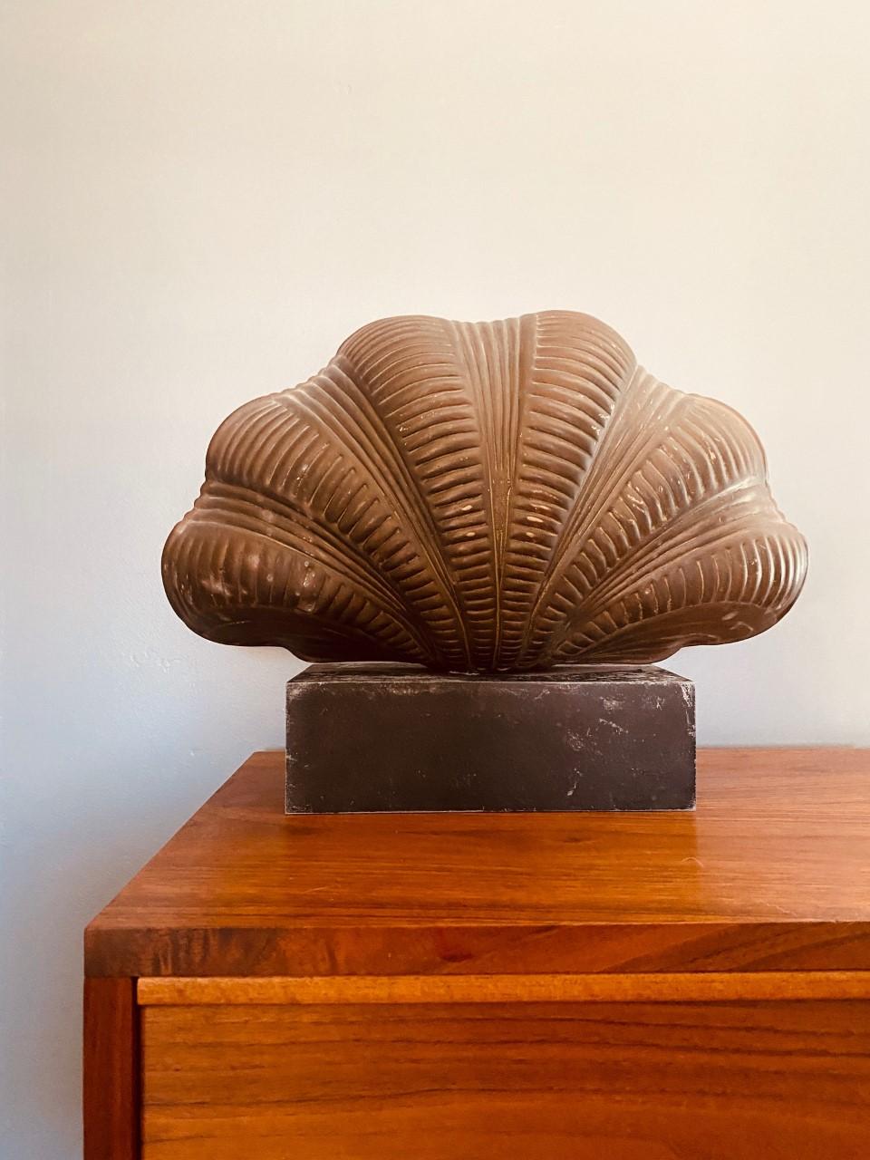 Organically beautiful and sculptural. This 1970s piece by Chapman is a style statement that brings form and function to your décor. Beautifully sculpted in brass, this sculpture rests over a metal base that solidifies its presence. Stylish and