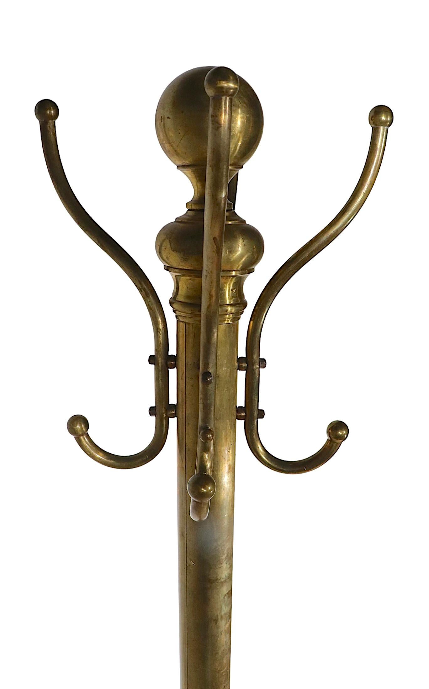 Freestanding architectural coat tree, rack, stand in brass, circa 1900/1940. This classic coat tree is in very fine, original condition, free of damage, repairs or missing parts. It is sturdy and stable, great at a doorway entrance to hang coats