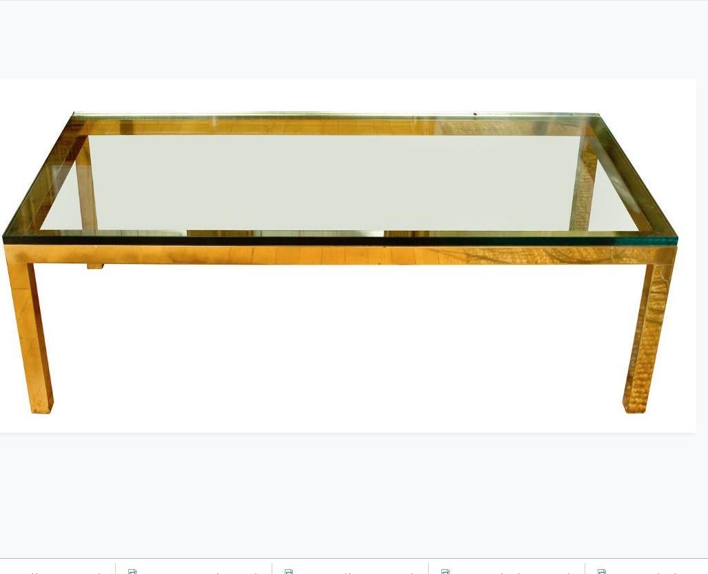 Vintage brass cocktail table with glass top.