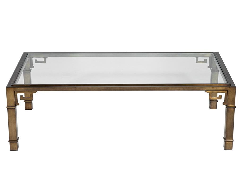 Vintage Brass Cocktail Table, a stunning piece that embodies the elegance of mid-century modern design from the 1970s. Crafted in the USA, this unique table features an intricately designed antiqued brass frame that showcases a captivating Greek key