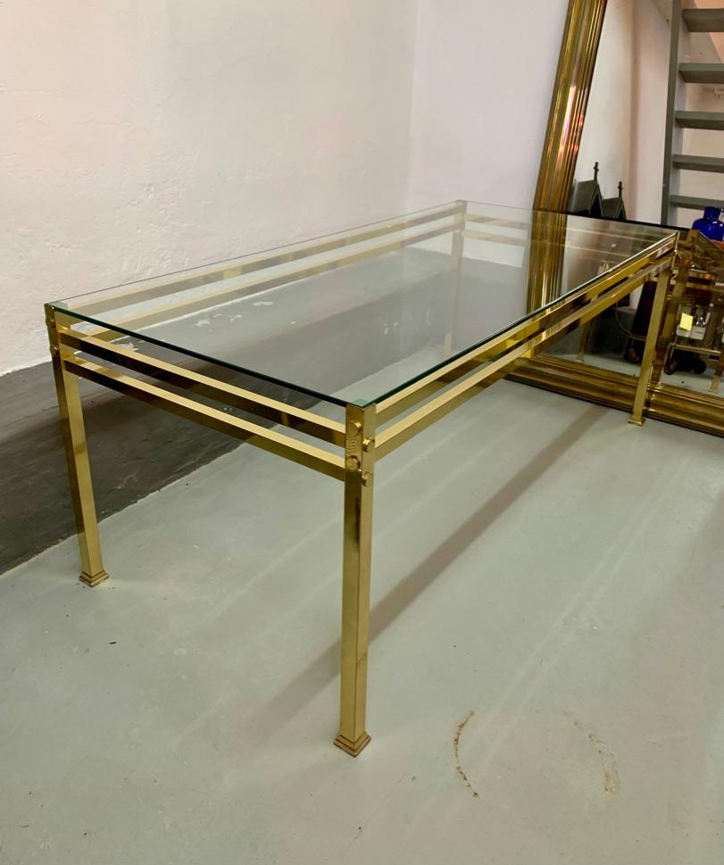 Chic vintage brass coffee table with clear glass top. Nice elegant design with detailed corners and legs.