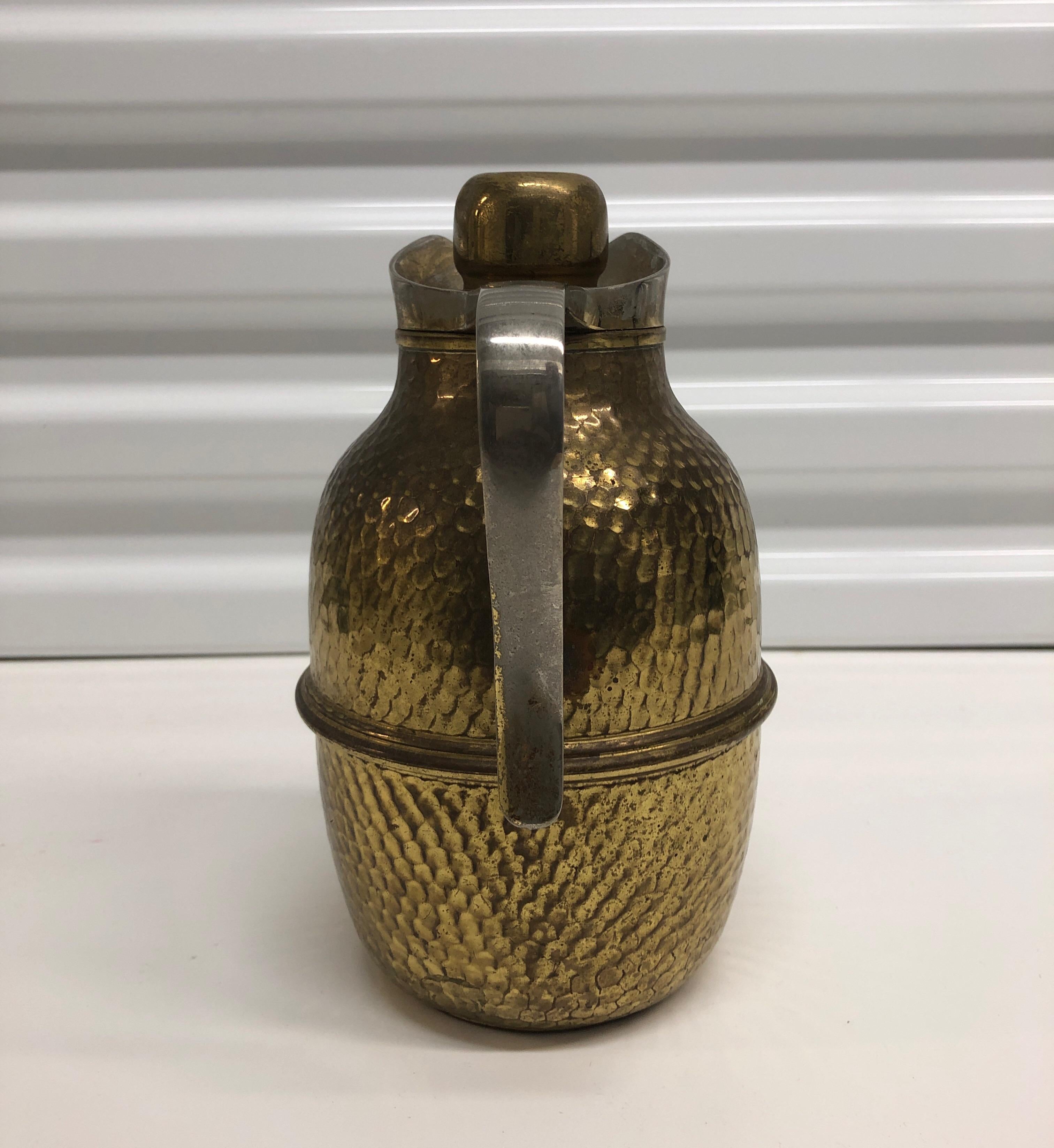 Vintage brass coffee thermos with handle. Isolating cover, hand blown mercury glass liner and cork stopper.
Hammered brass textured in the body, nice polished brass patina.
Made in Italy for Neiman Marcus.
Size: 5' D x 8.5