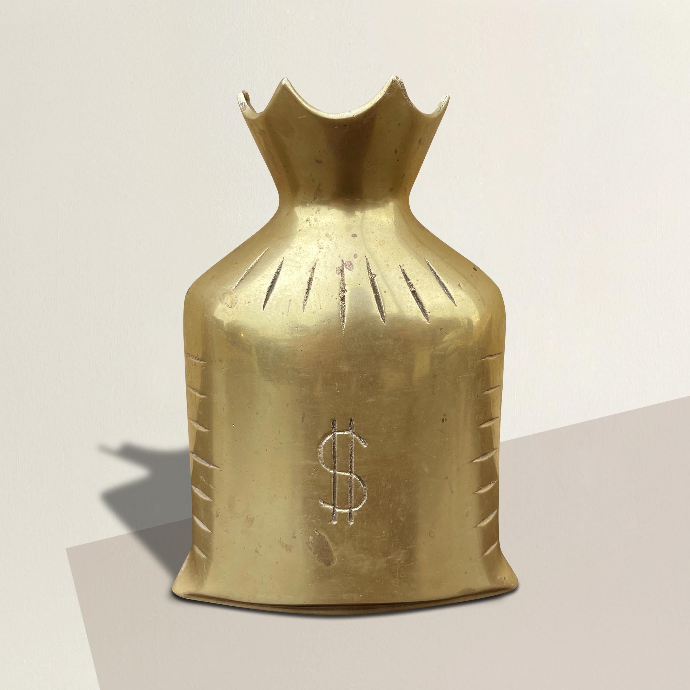 A vintage brass coin bank in the form of a money bag with a large dollar sign on both sides. Coins are inserted in the top, and can be easily removed by turning the bad over and shaking.