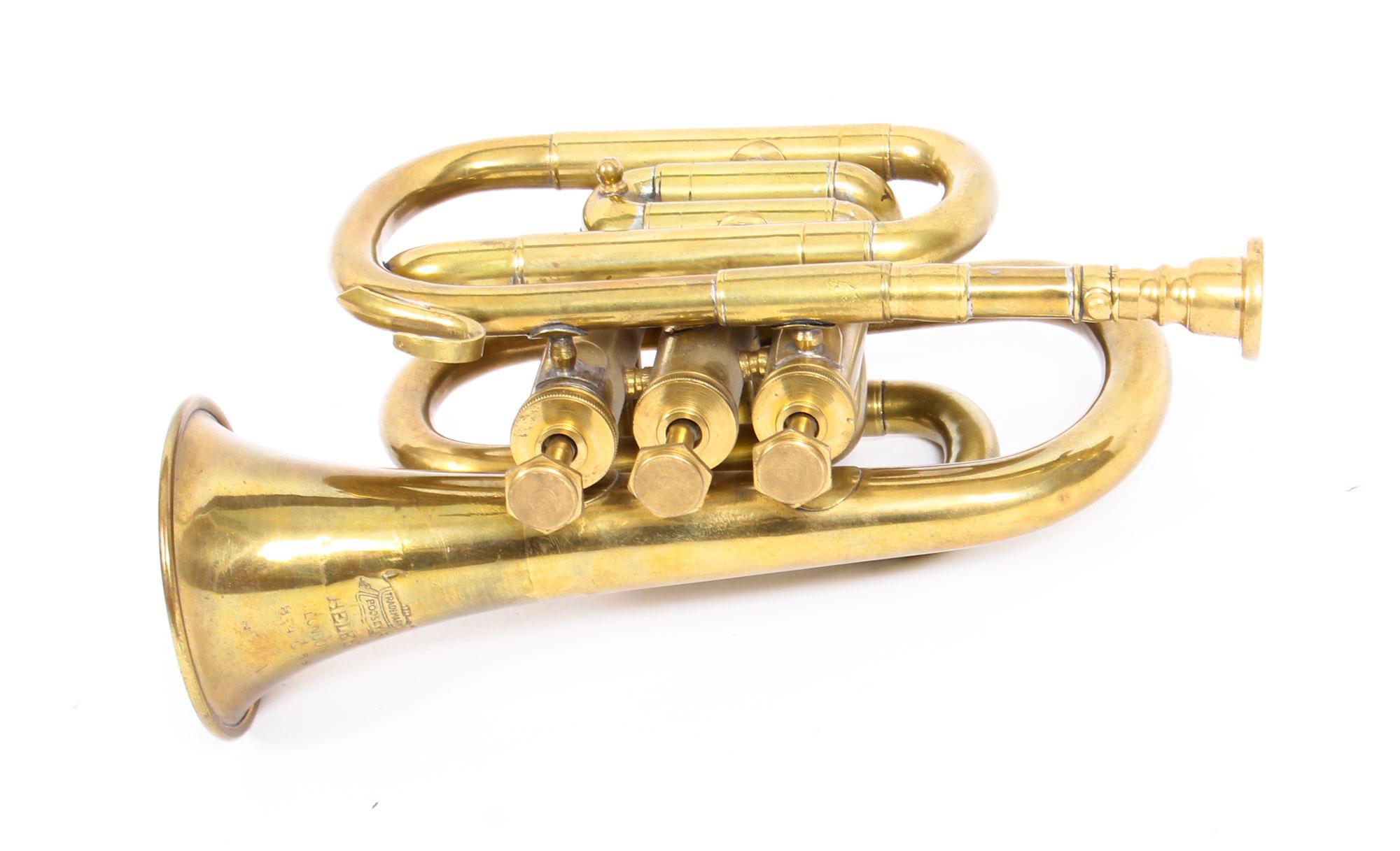 This is a splendid Vintage English brass pocket cornet by the world-famous music publishing and manufacturer of musical instruments, Boosey, London, circa 1950 in date.
 
As typical of brass cornets, this truly charming musical instrument has a