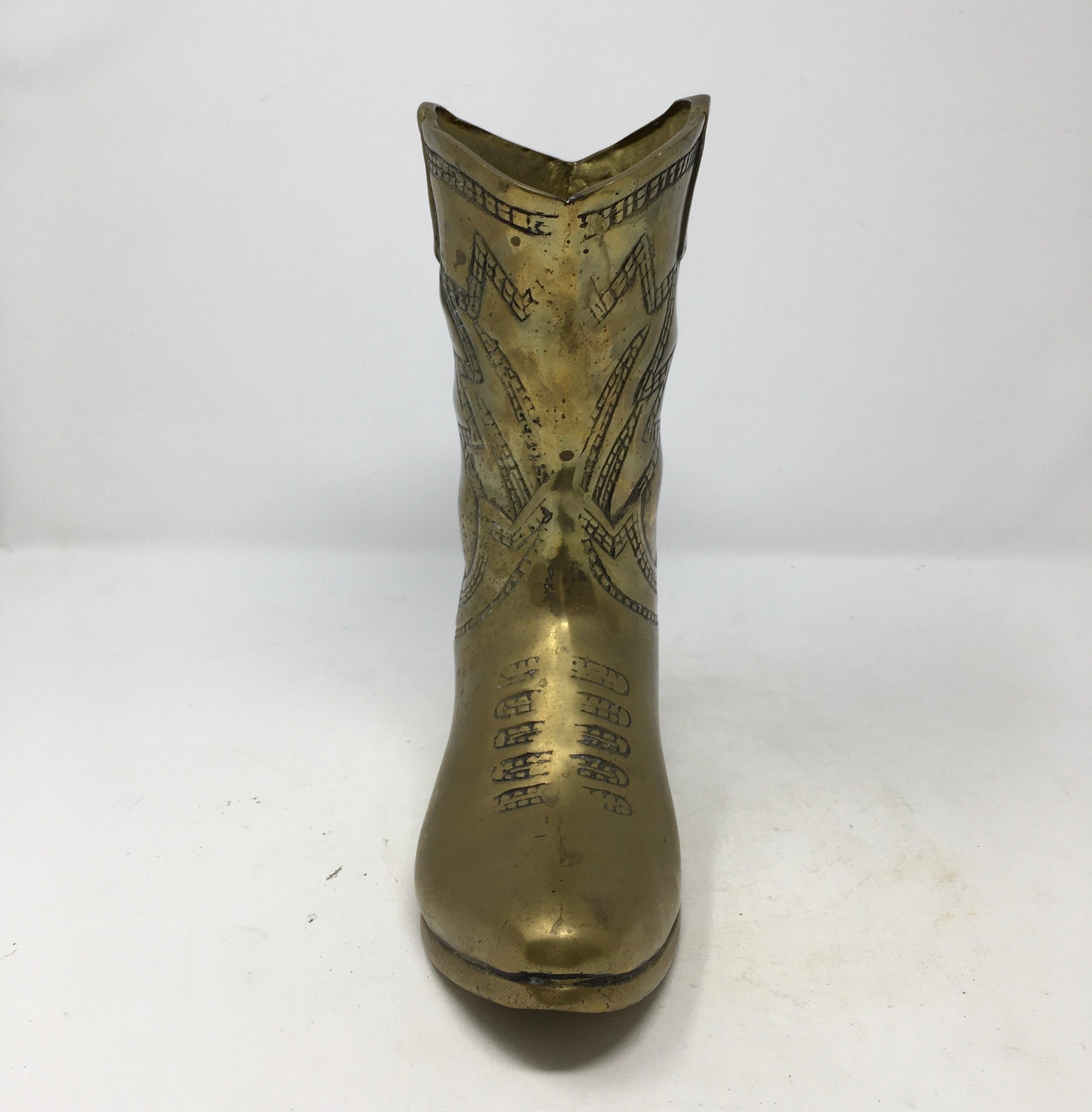 A vintage solid brass western style cowboy boot with a molded design. Nicely detailed, this piece would display well in a home or office.

This piece weighs 4 lbs.