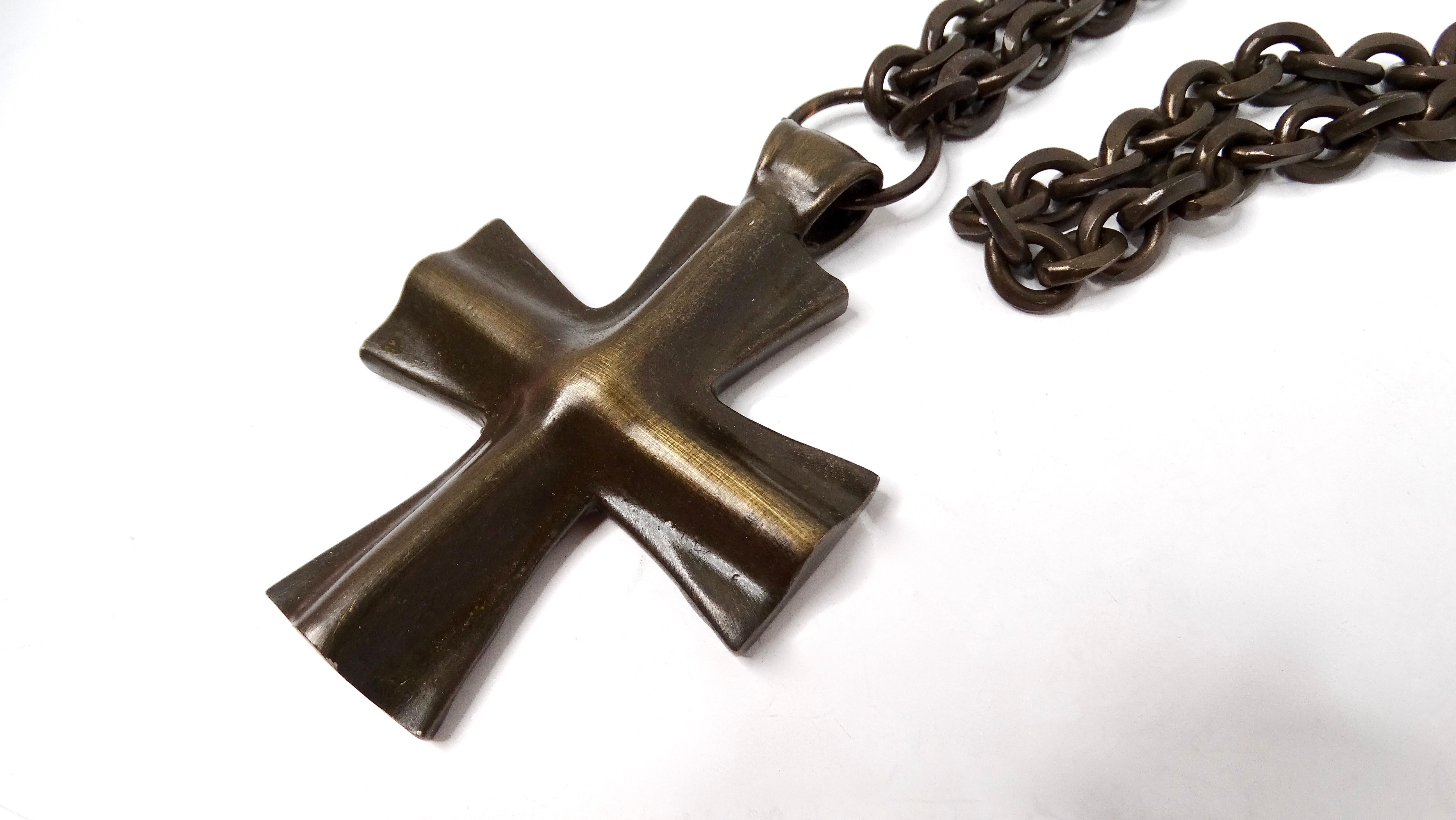 The Vintage Brass Cross Pendant Long Chain Necklace is a striking piece that marries classic elegance with a bohemian flair. This beautifully crafted necklace features an intricately designed brass cross pendant that hangs gracefully from a long