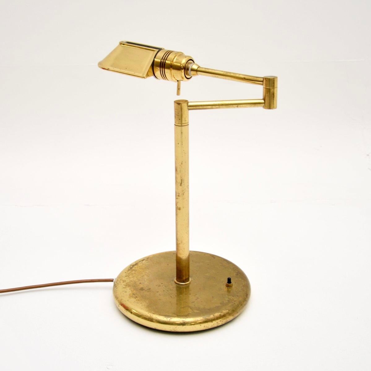 A stylish and very well made vintage brass desk lamp, made in England and dating from the 1970’s.

It is of superb quality and is very heavy for its size. It is solid brass, it sits on a circular base and has an articulated shaft, so the shade can
