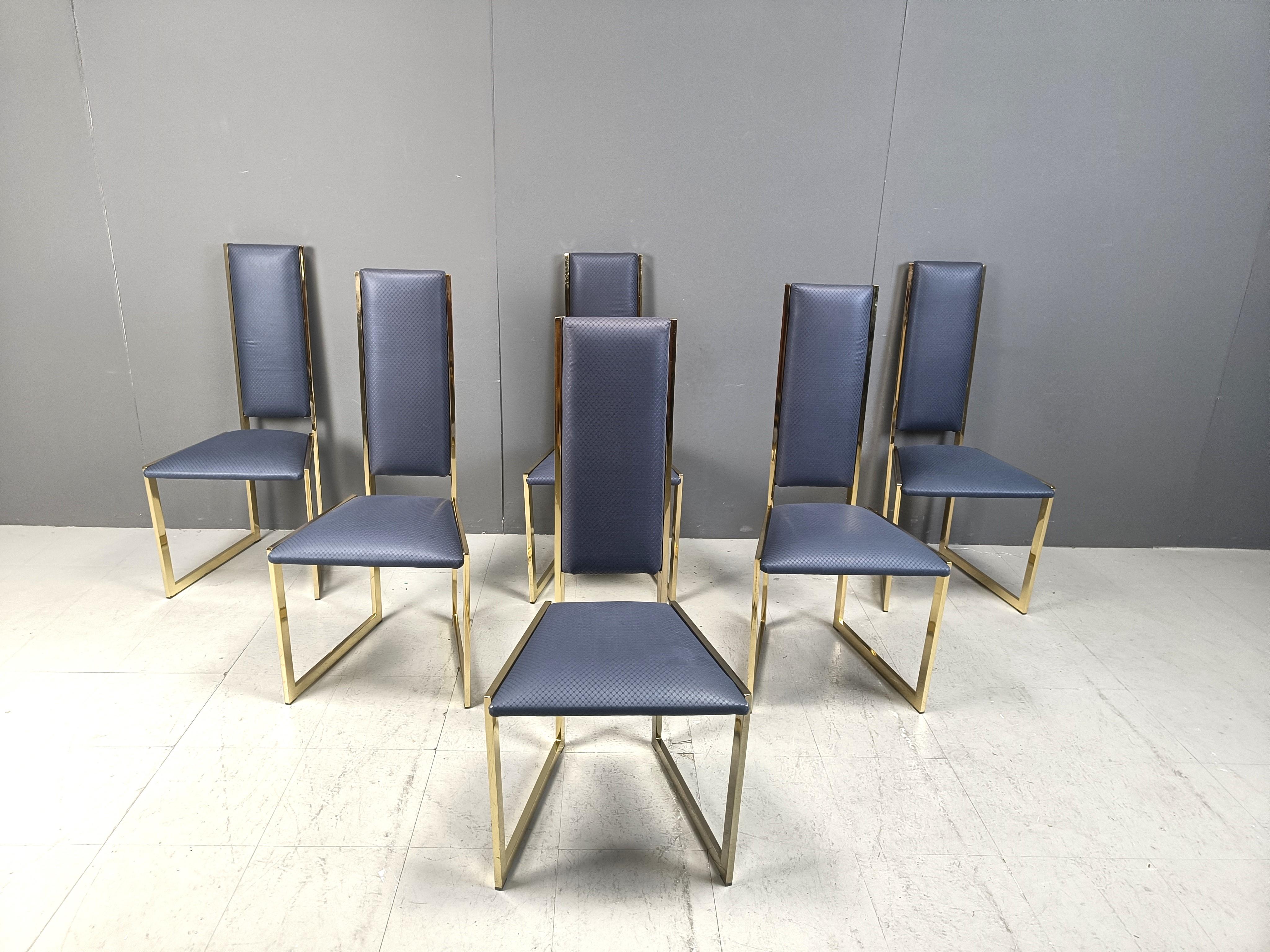 Unique brass dining chairs with a G shaped frame and blue skai/leatherette upholstery.

Elegant design, timeless.

1970s - Belgium

Very good condition with normal age related wear.

Dimensions:
Height: 105cm
Width: 50cm
Depth: 50cm
Seat  height: