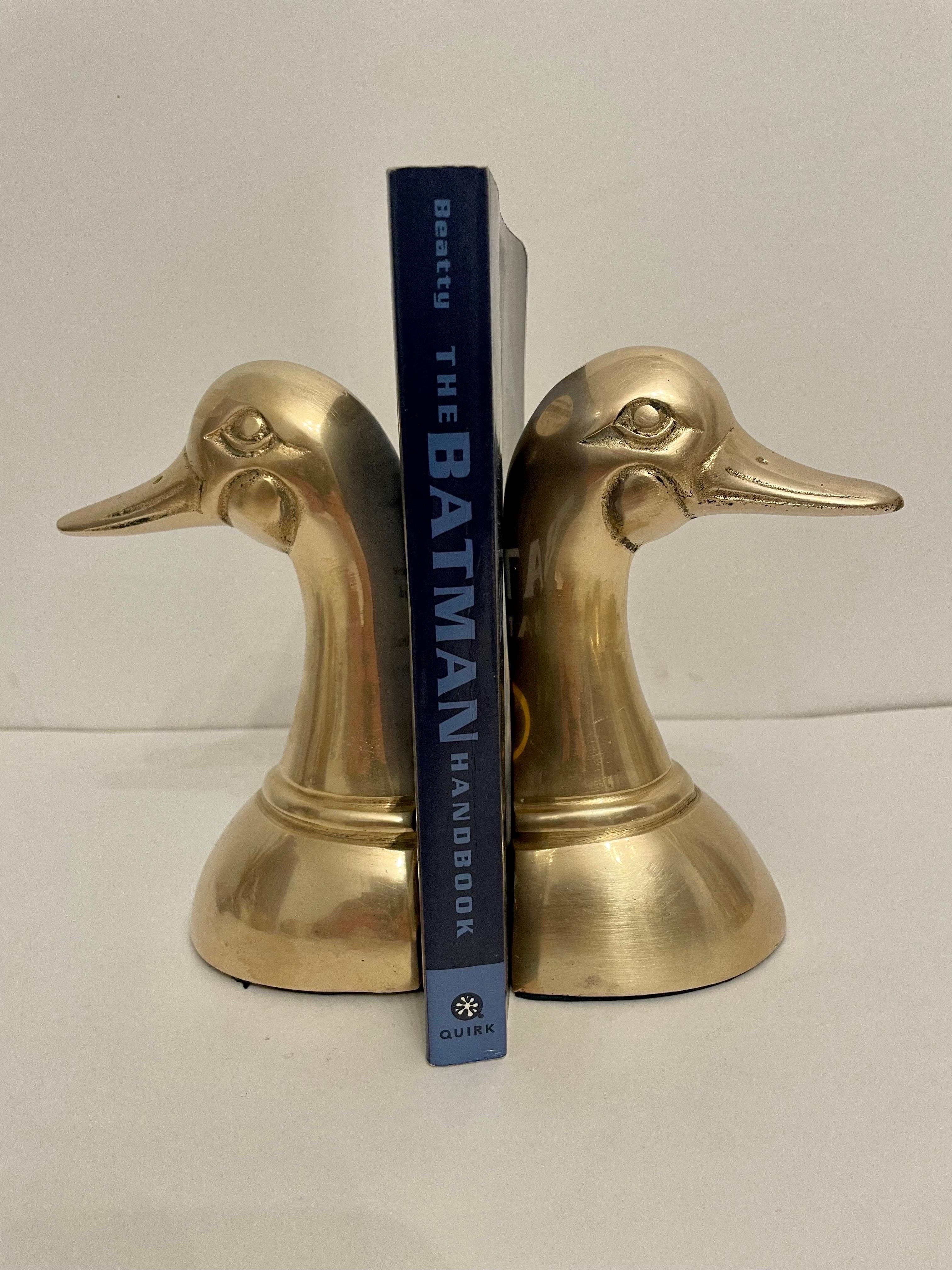 Vintage brass Duck bookends. Larger size. Good condition. Has nice size to hold a stack of books. Great for your desk or bookshelf. Any dark areas are reflection only.