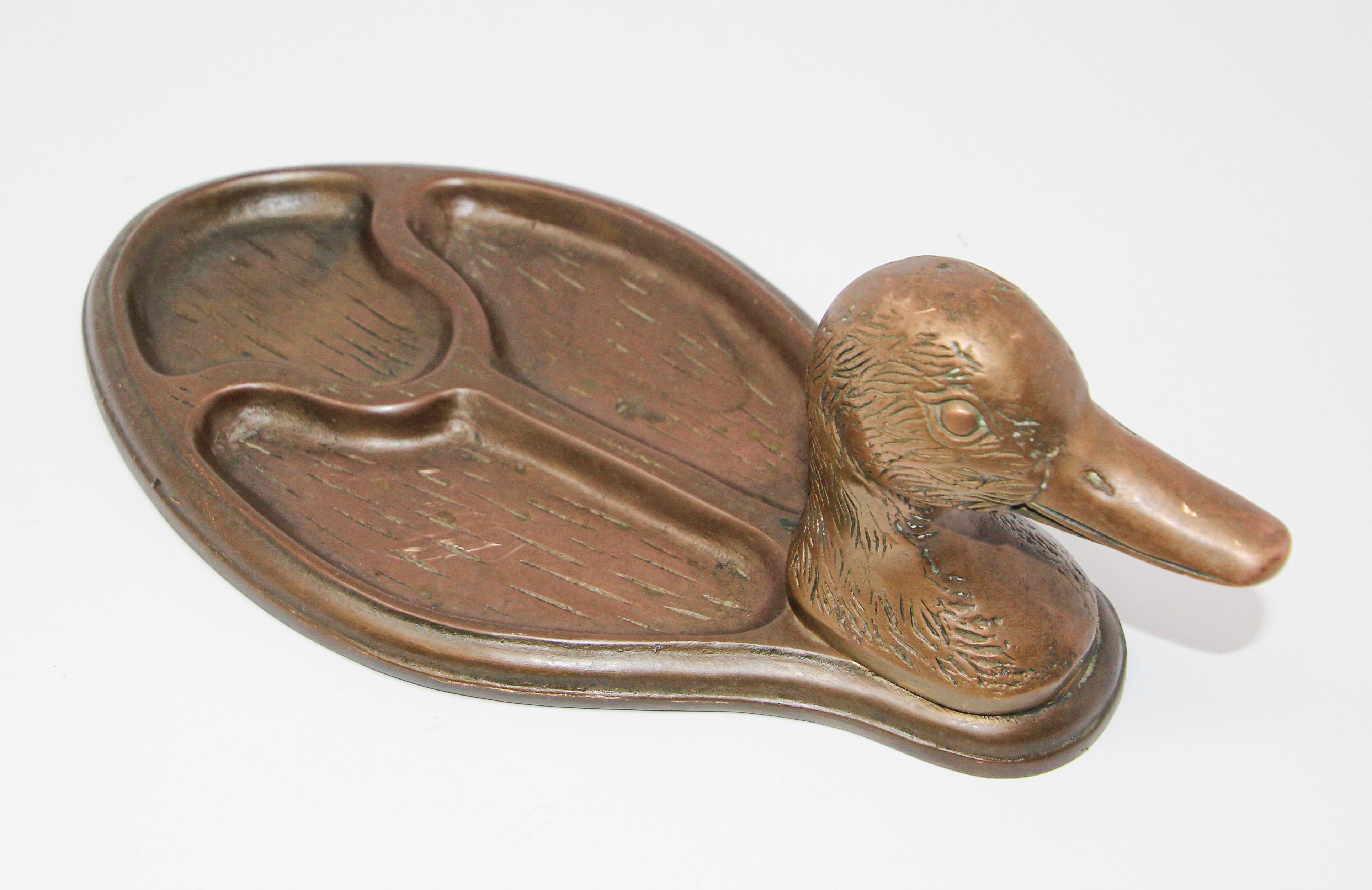 Handcrafted decorative vintage collectible brass valet tray duck head shape.
Beautiful handcrafted large cast brass bird form this handsome trinket tray is very well made and large scale.
A vintage solid brass mallard duck head compact tray for