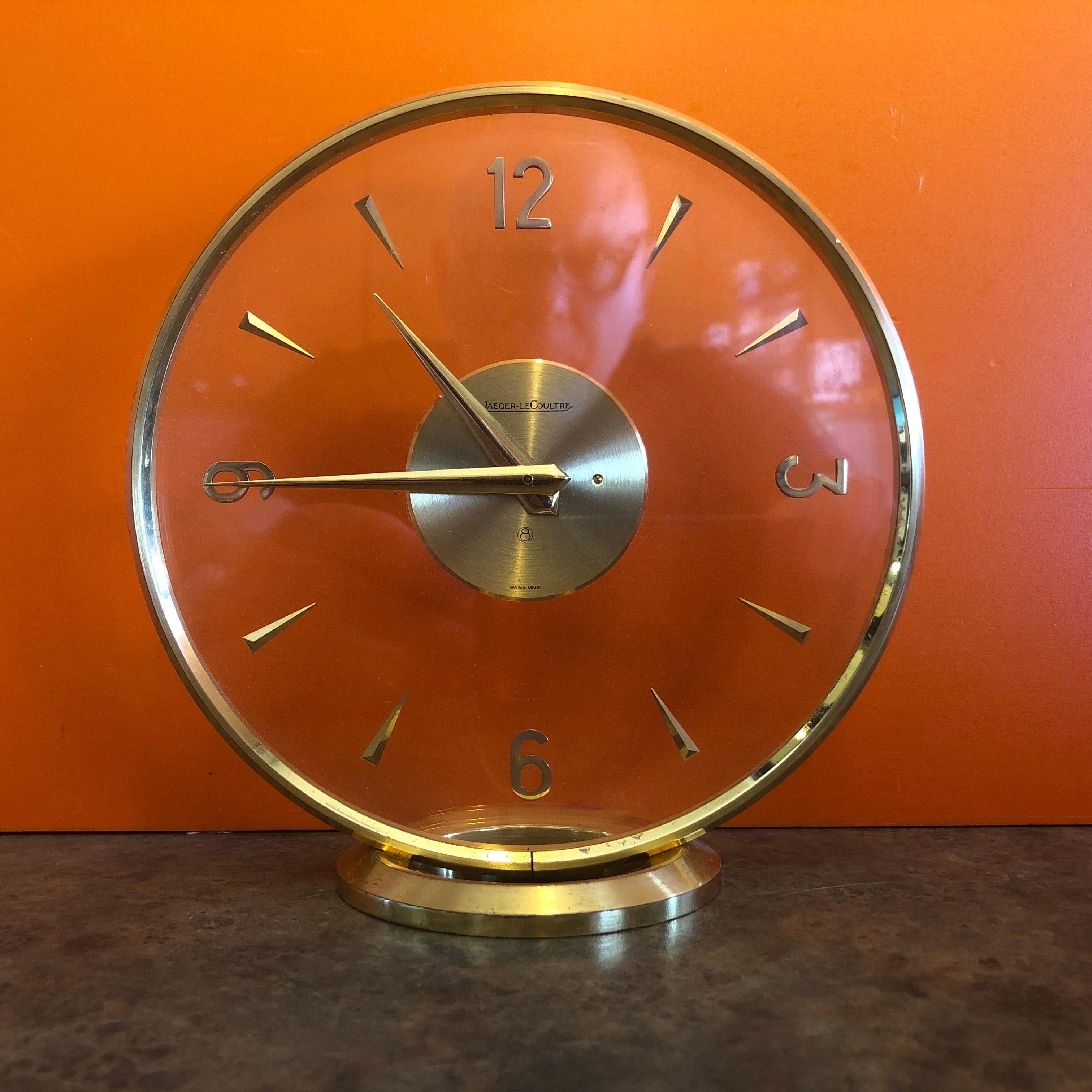 Lovely vintage brass eight day mystery desk clock by Jeager-LeCoultre, circa 1960s. The clock is Swiss made and has the model number #334 on the underside. The piece has an innovative case construction with two crystals; the back crystal is holding