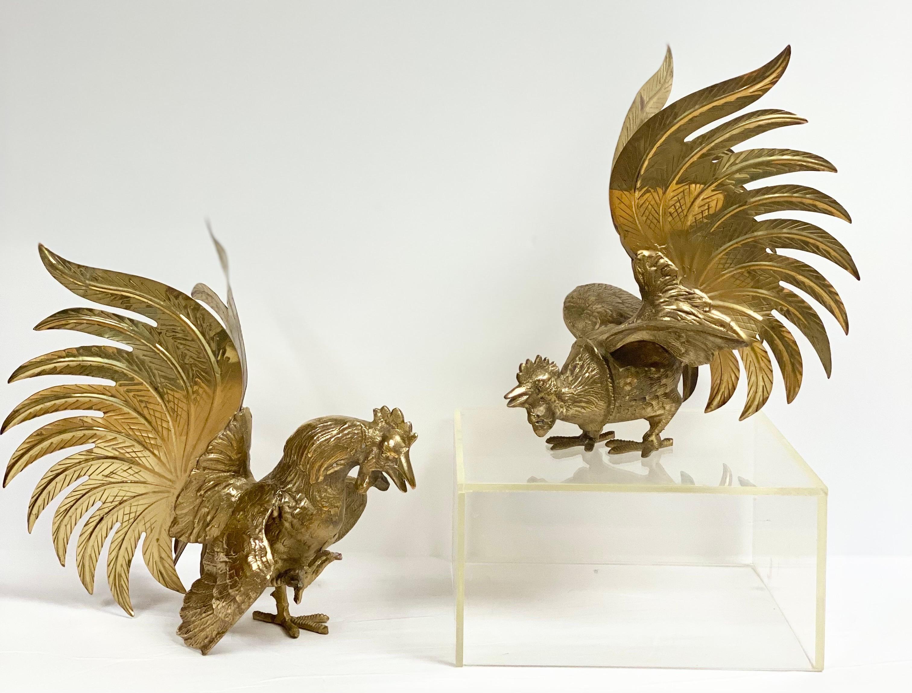 We are very pleased to offer a stunning pair of vintage figurine roosters, circa the 1960s. Each statue is handmade from a high-quality brass material and sculpted with lifelike details. This pair is an eclectic set that will surely add height and
