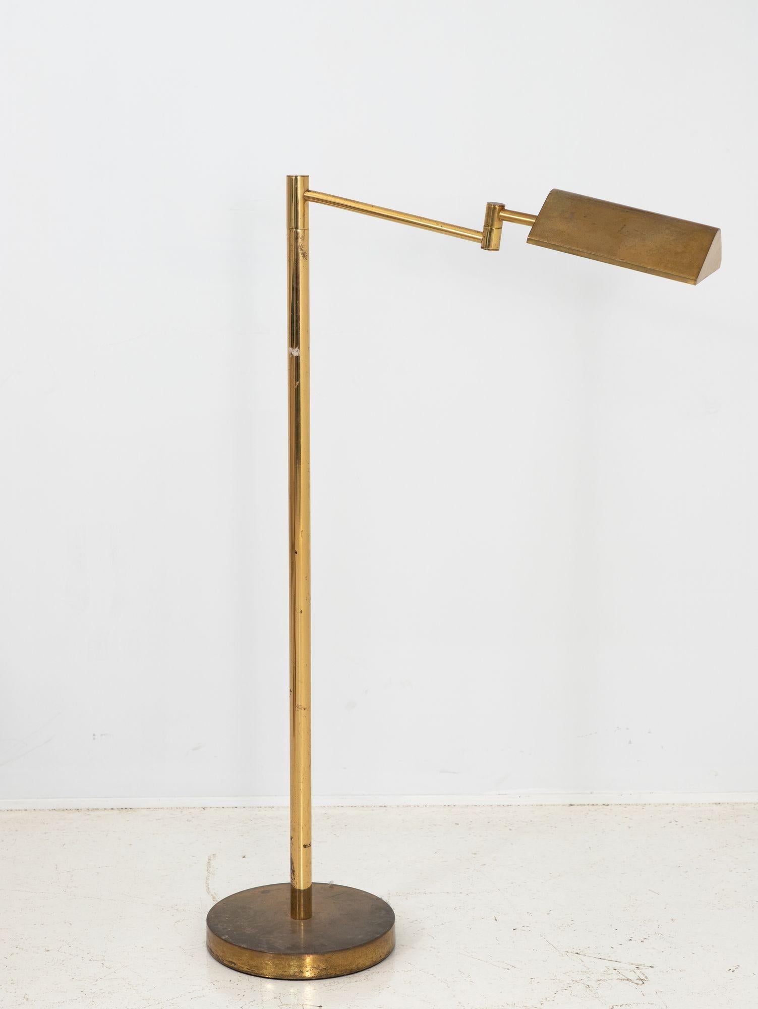 Illuminate your space with timeless elegance using this vintage brass floor lamp featuring a convenient swing arm. This lamp exudes sophistication and charm. The lustrous brass finish adds a touch of glamour to any room, while the swing arm allows