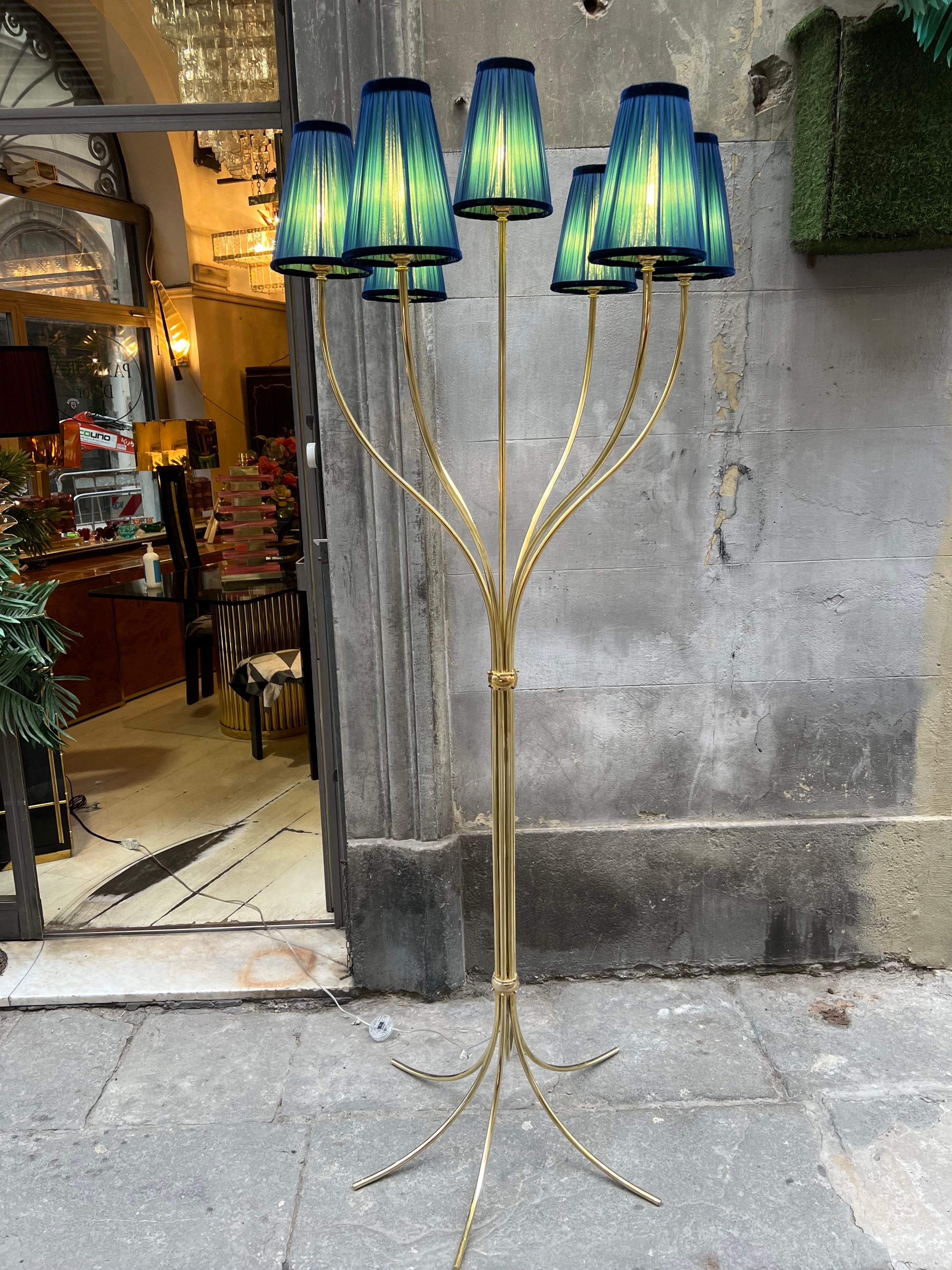 Vintage brass floor lamp with 7 brass arms each ends with its lampshade. Our Lampshades are handcrafted in double pleated silk chiffon, green inside and blue outside. When the light is on the colors mix creating an amazing effect.
The floor lamp has