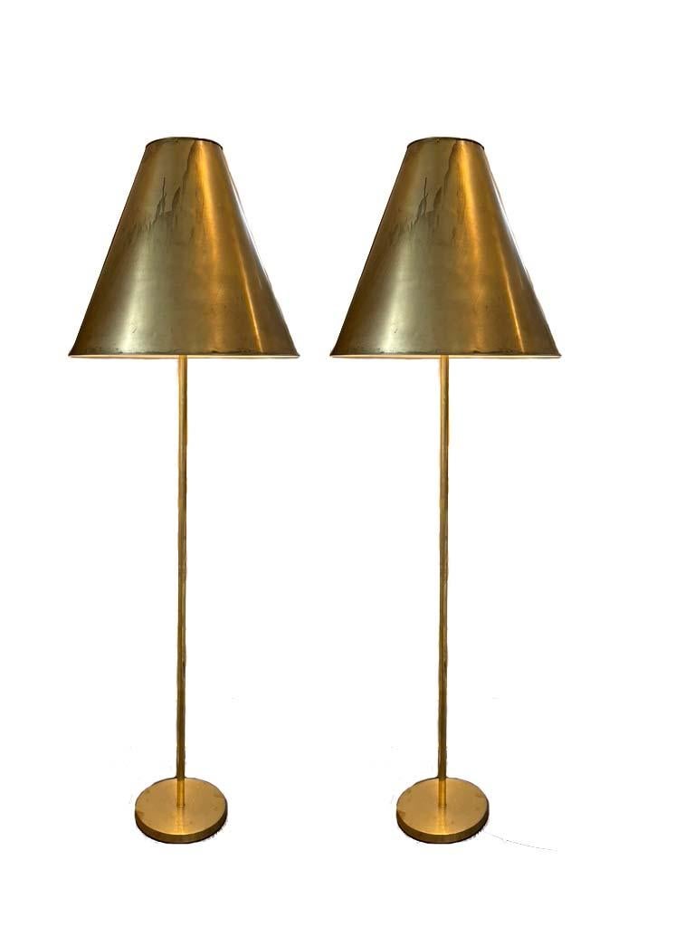 A wonderful large scale pair of vintage pendants made into floor lamps. the brass is older but the lamps have all been updated and rewired. the brass has patina but can be cleaned if desired.
 