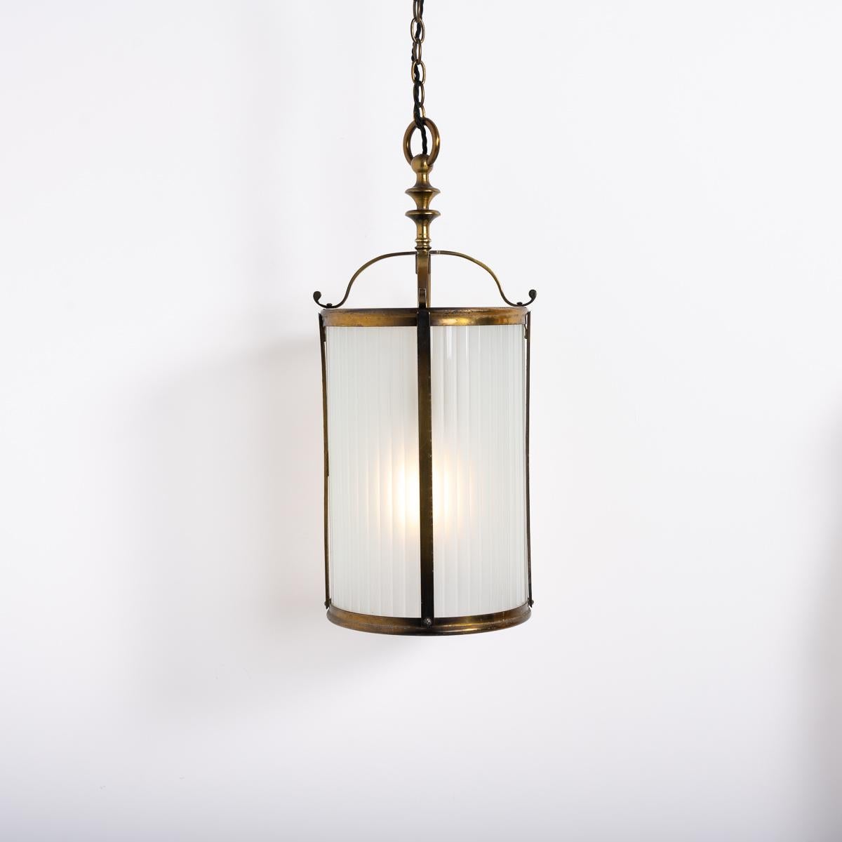 Antique Brass and Frosted Glass Hall Lantern
A good quality brass framed hall lantern of large size.

Two curved reeded opaque glass panels sit inside the lantern and emit a beautiful soft and warm glow when illuminated.

English made circa