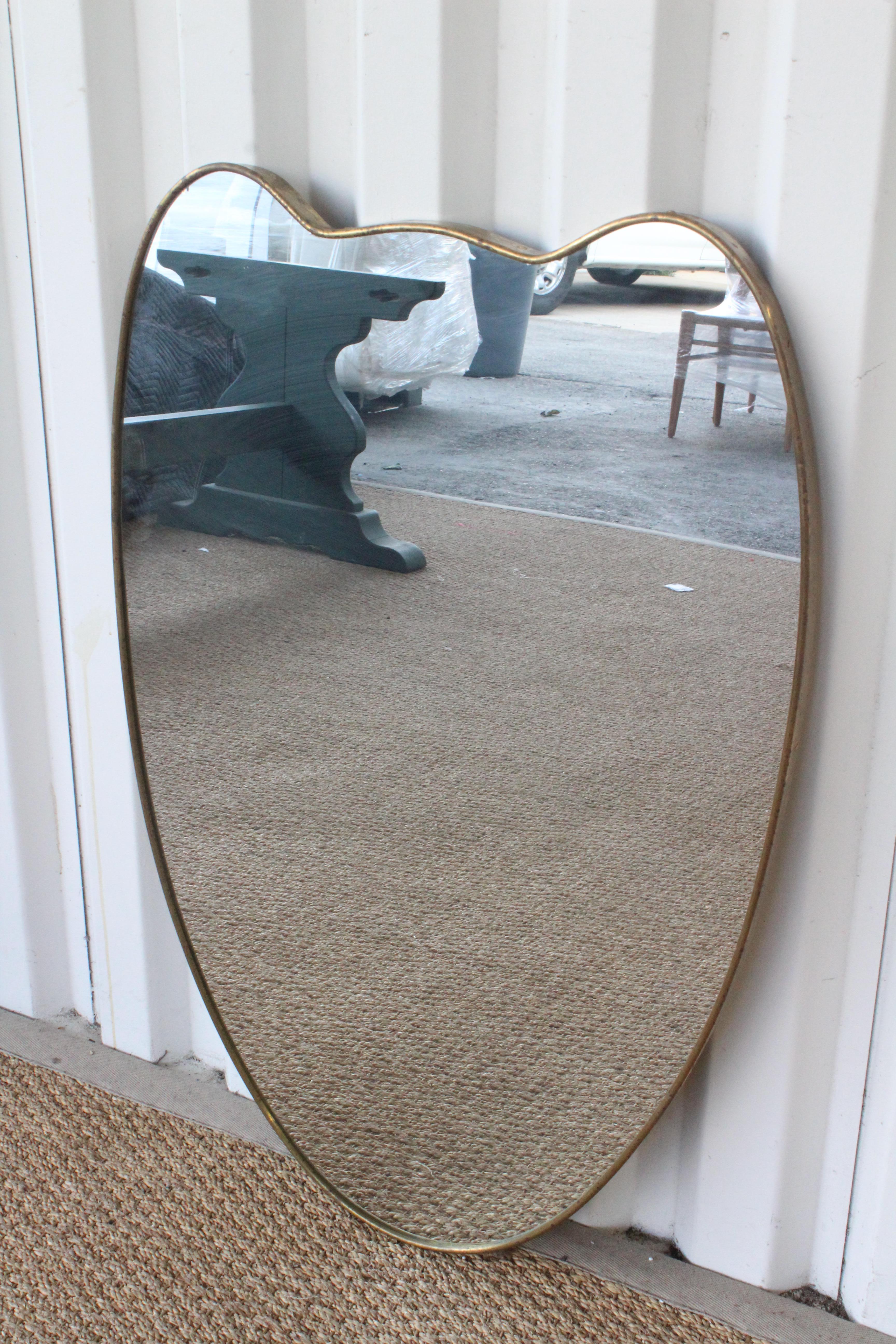 Vintage brass framed wall mirror, Italy, 1950s. In good condition with age appropriate patina to the brass frame. Back of the frame shows wear.