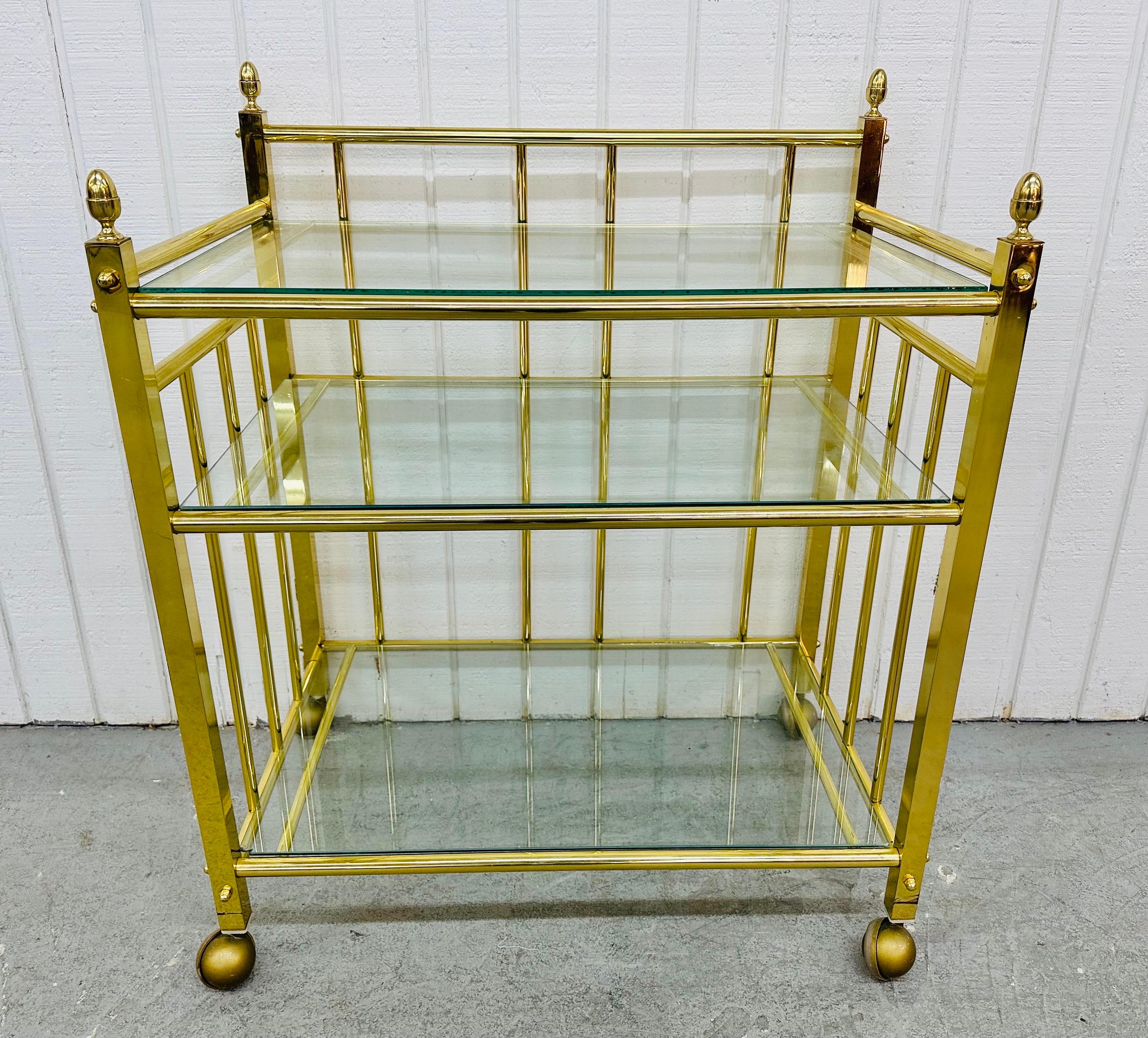 This listing is for a vintage brass and glass bar cart. Featuring a straight line design, brass frame, three glass shelves for storage, wheels for easy transport, and brass finials! This is an exceptional combination of quality and design!