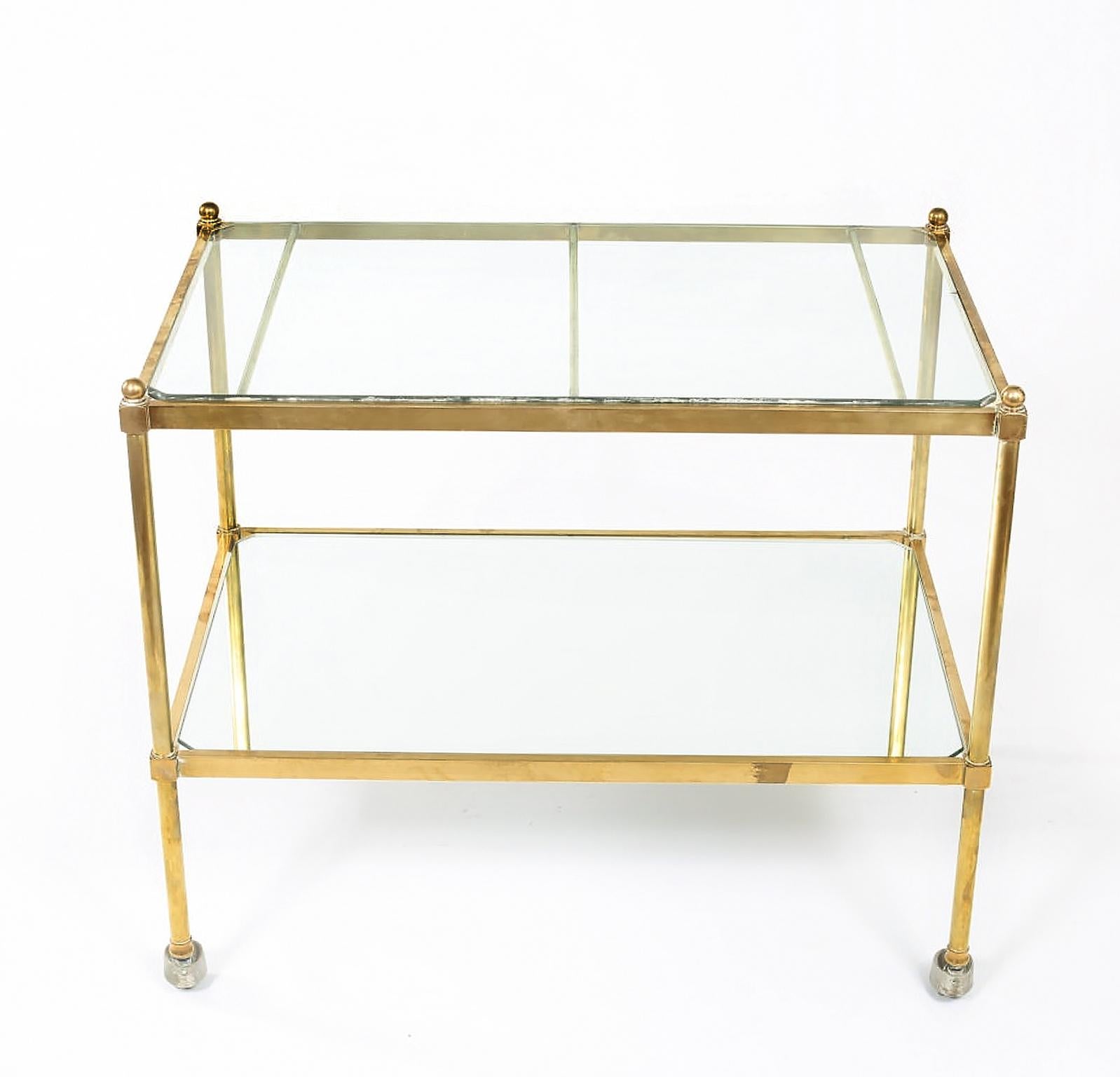 Stunning Italian two-tiered brass / glass / mirror bar cart. The top shelve is glass with the exception of the bottom shelve which is mirror shelve. The bar cart is in good vintage condition with wear appropriate to age / use. The cart measure about