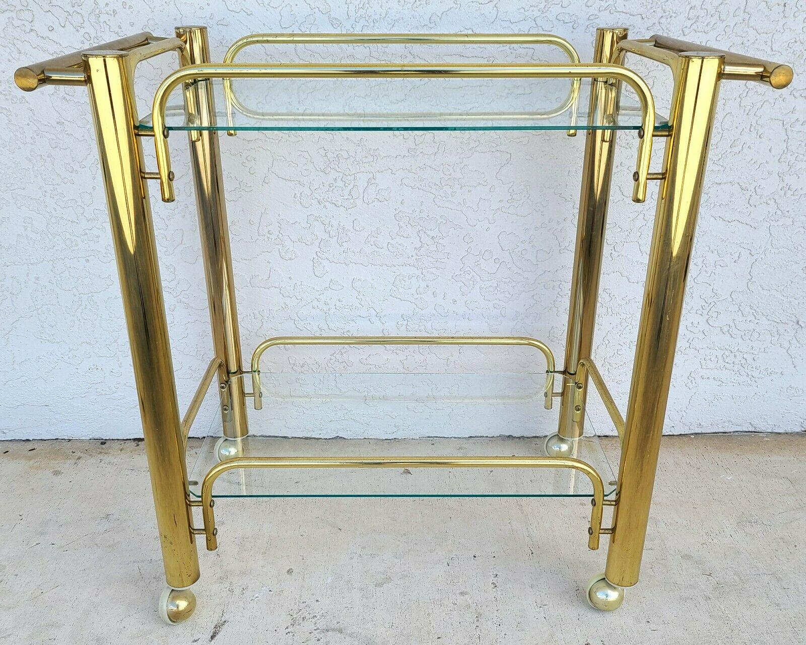 For full item description be sure to click on CONTINUE READING at the bottom of this listing.

Offering one of our recent palm beach estate fine furniture acquisitions of a vintage brass & glass rolling bar serving cart

Approximate measurements