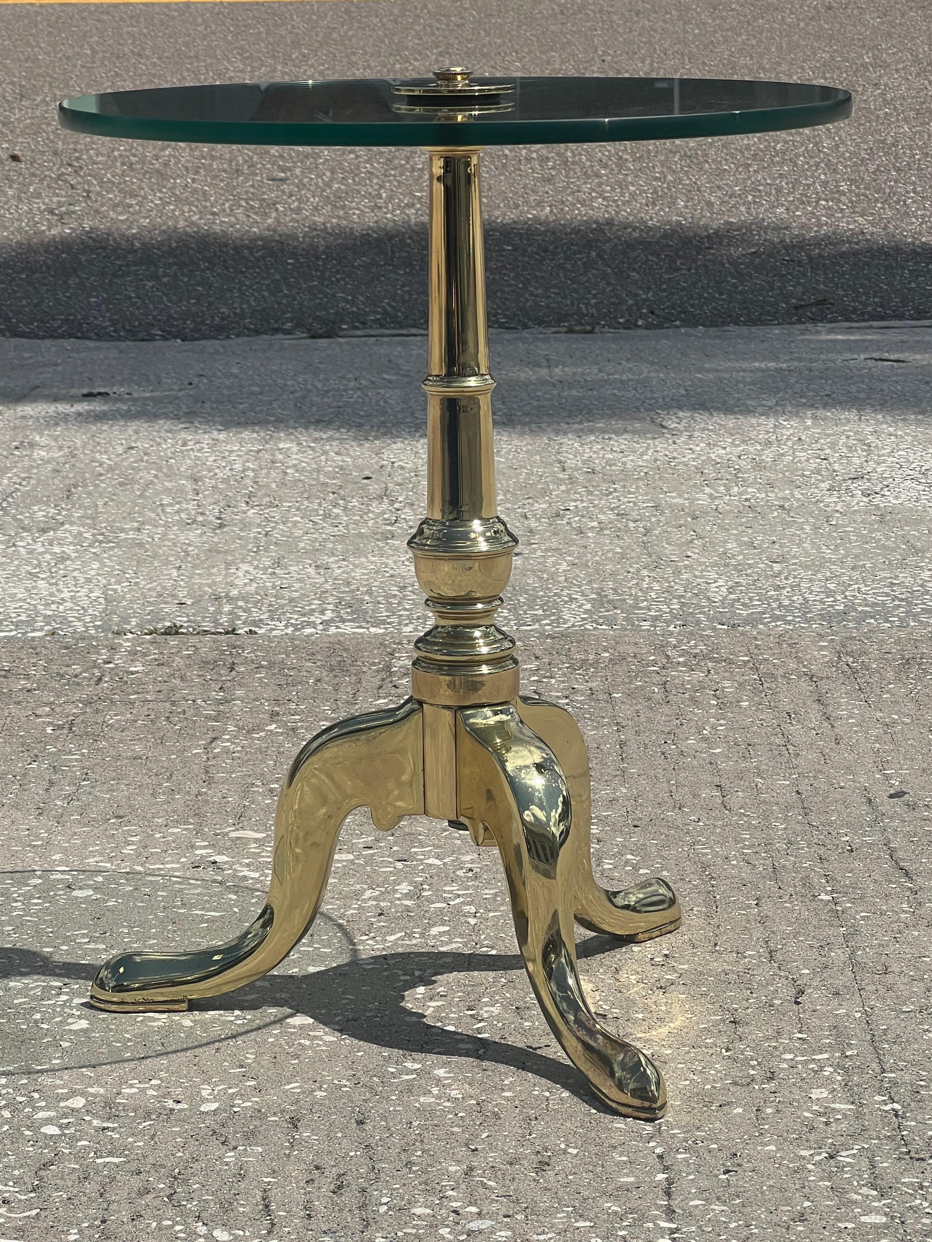 An elegant brass gueridon with glass top. Heavy and well made. Fits in with modern or traditional interior.