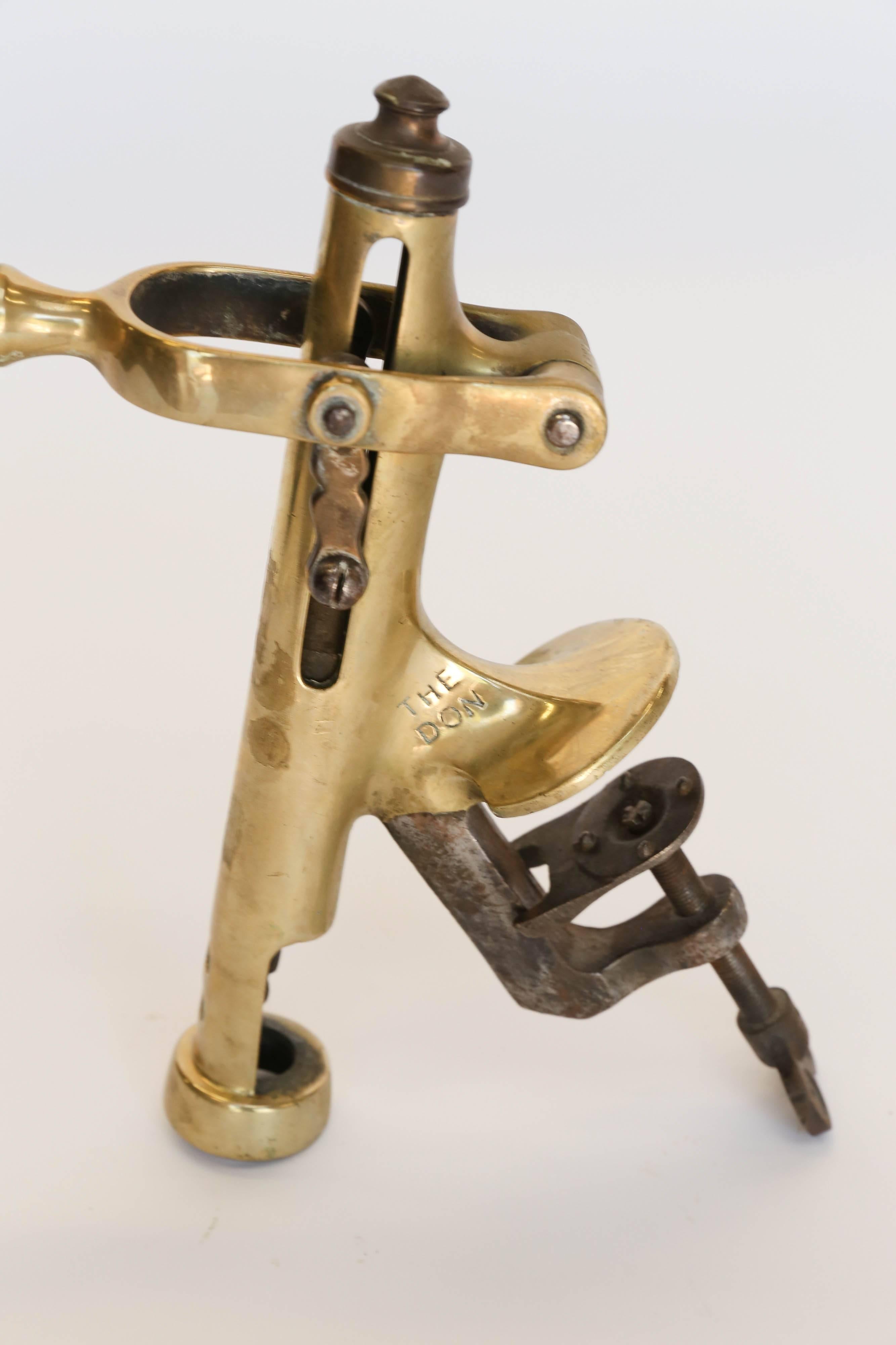 Vintage Brass Cork Screw Hand Crank Wine Bottle Opener. This is a Vintage Wine Bottle Opener that can be attached to a counter or bar. Beautiful wood handle and solid brass base.