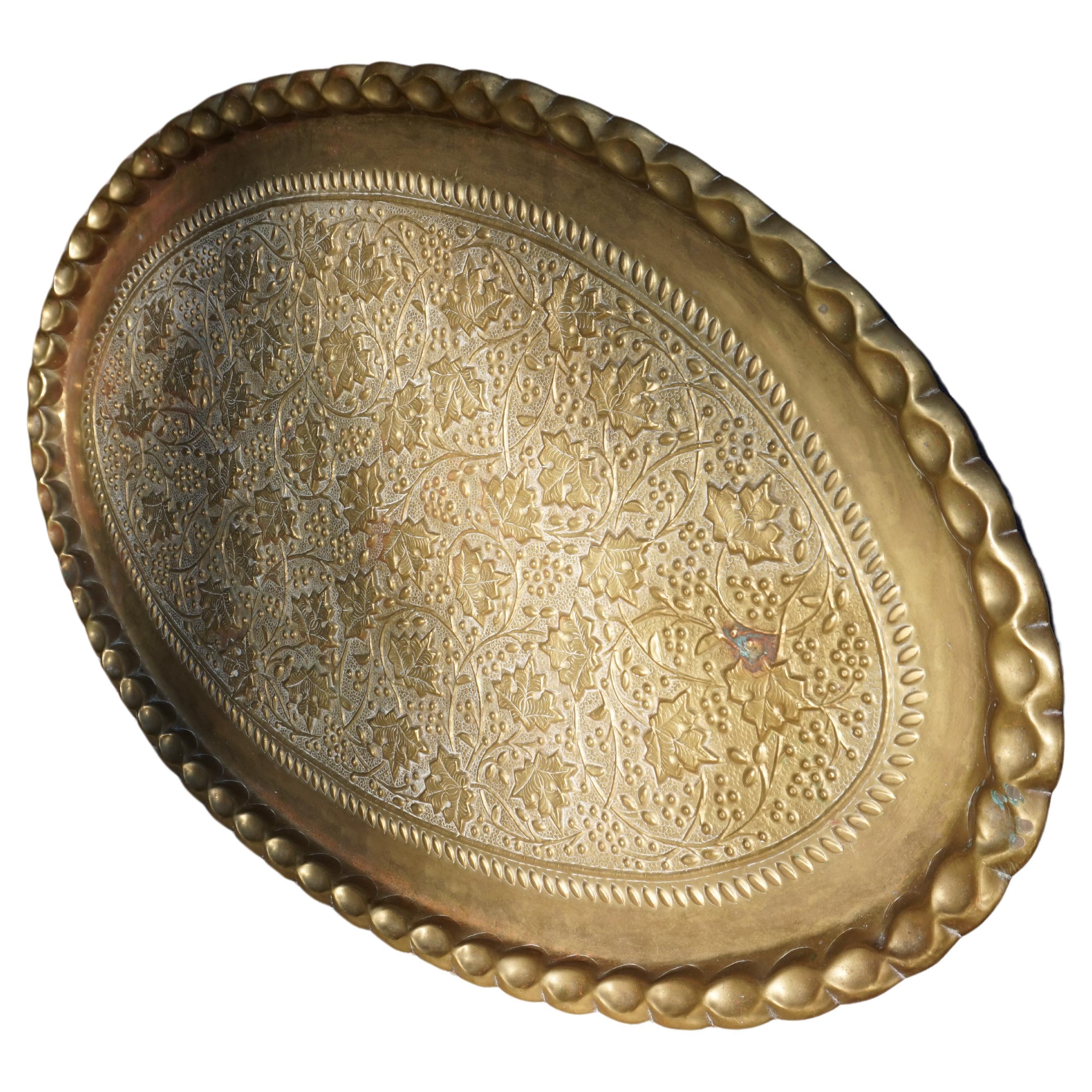 Rare extra large solid brass hand engraved British India platter. Gadrooned edge, sheer size and deep relief engravings with floral theme make this platter stand out. A beautiful piece to incorporate on a coffee or dining table or simply use as an