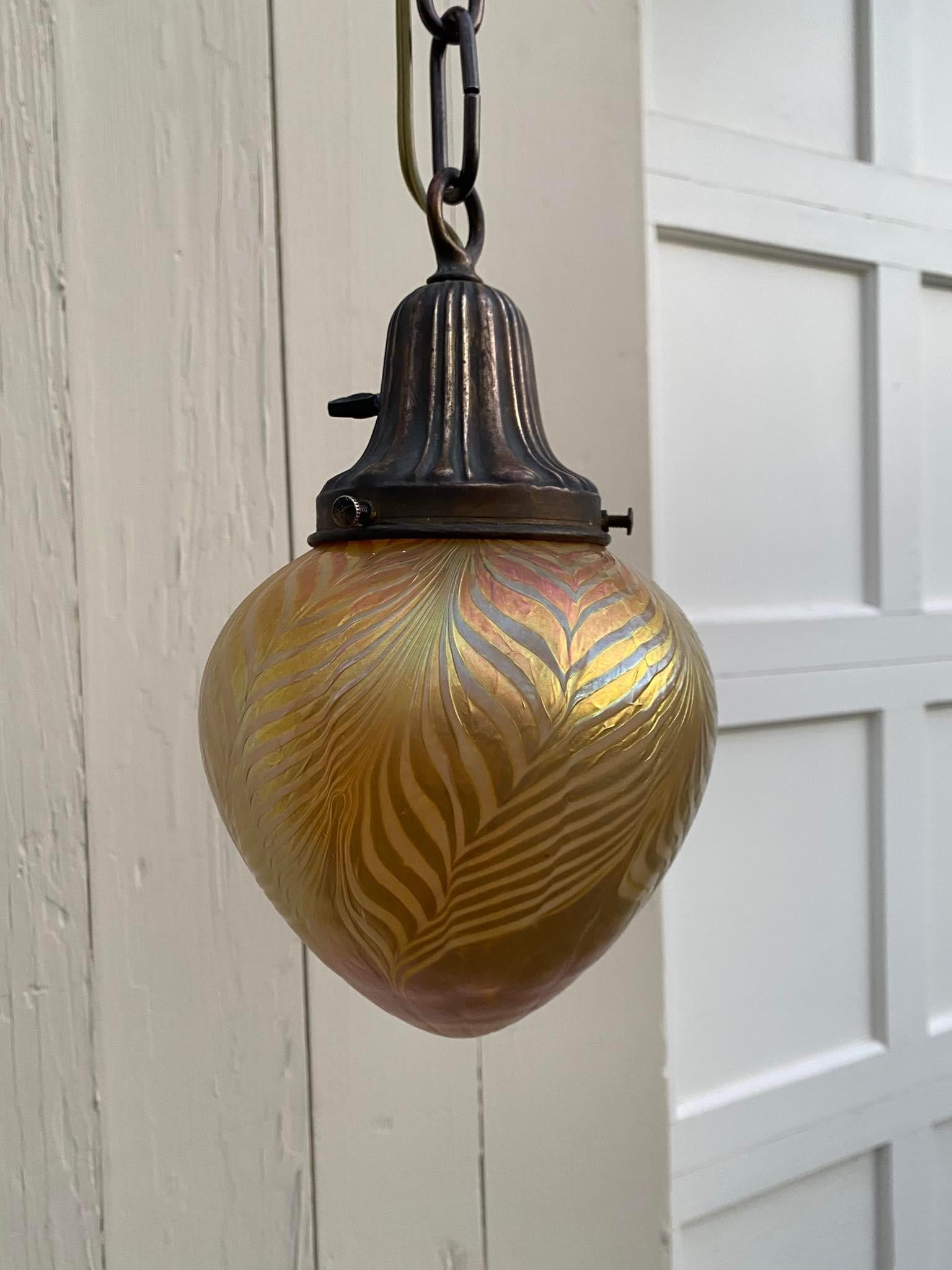 This is an amazing art glass shade produced by world renowned glass blowers Lundberg Studios in Davenport, California. It is attached to a vintage fully restored brass fixture, wired and ready to install. We ship everywhere. Follow us here for more