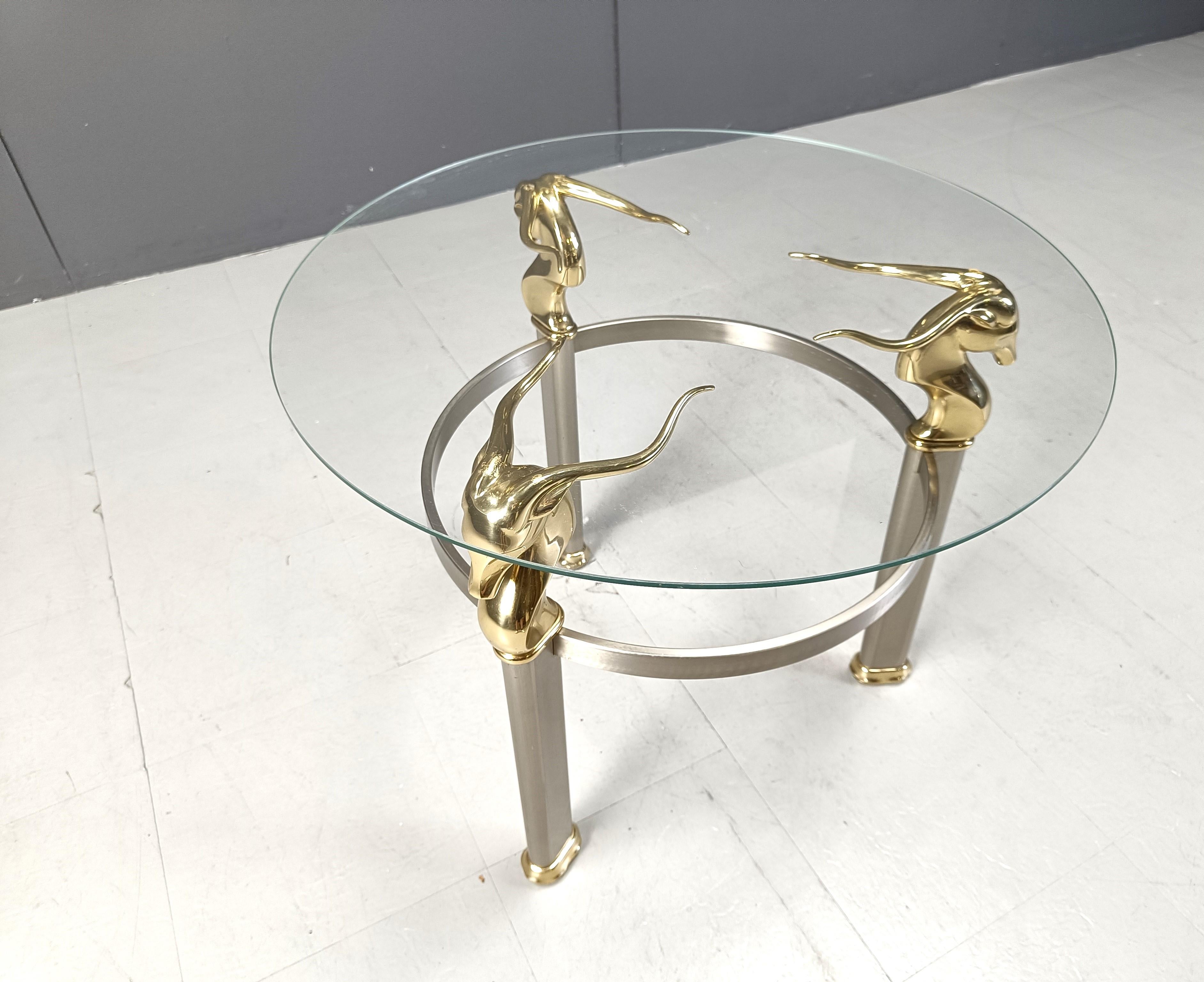 Minimalist design ibex or ram head side table with brass figures, a brushed aluminum base and a clear round glass top.

Timeless, decorative side table

1970s - Belgium

Dimensions:
Height: 57cm
Diameter: 70cm

Ref.: 427078