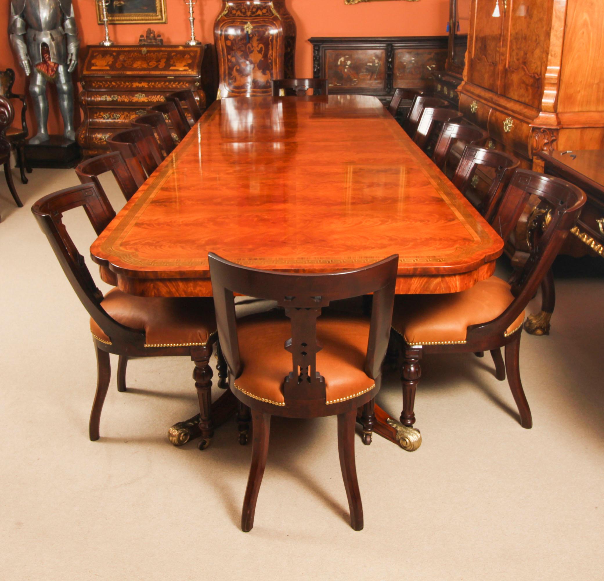 This is a fabulous Vintage Regency Revival dining set comprising a dining table, mid 20th Century in date, and a set of fourteen antique Athenian dining chairs,Circa 1870 in date.

The fabulous Vintage brass inlaid Regency Revival dining table is