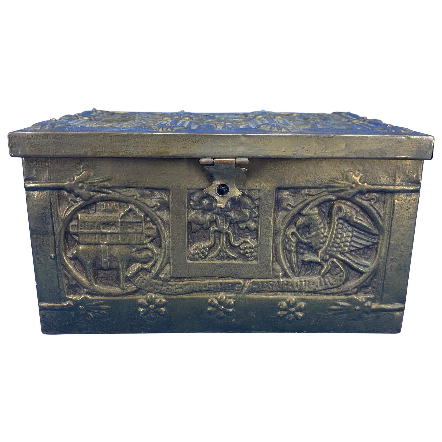 Vintage brass jewelry box with religious scenes
The box has a wooden insert.